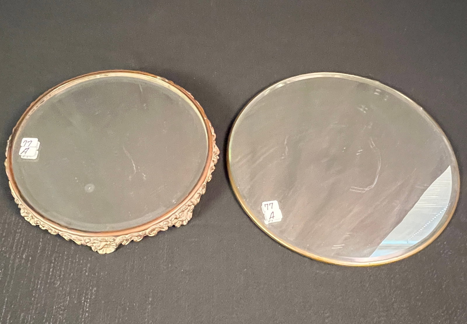 Two Mirrored Plateaus: Two mirrored plateaus, one with a fancy decorative base, both with beveled edges. The Fancy base measures 10" round and the other measures 12" round. In excellent, house ready condition. And one