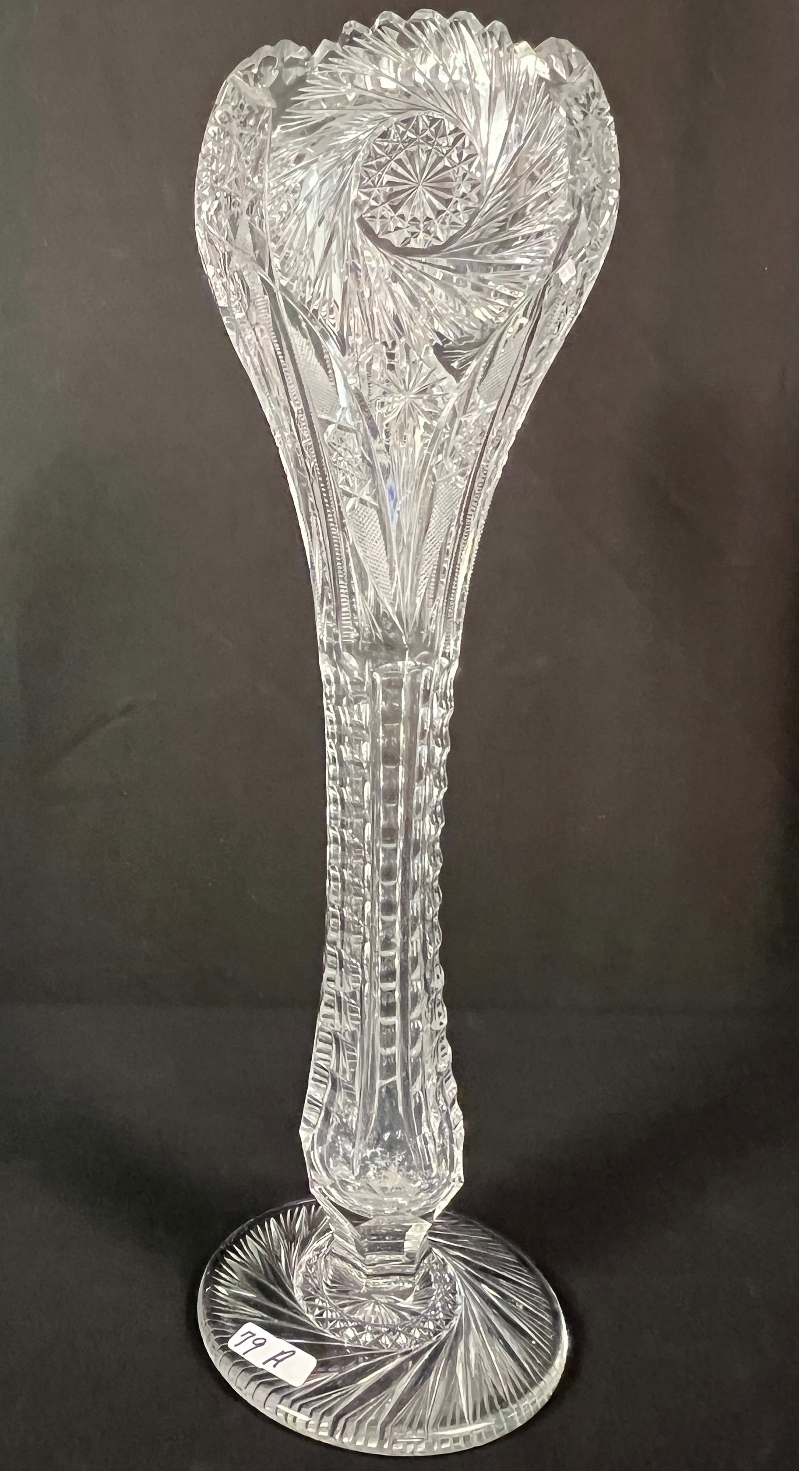 Victorian Brilliant Cut Glass Trumpet Vase: A Victorian brilliant cut glass trumpet vase with saw tooth edging, zipper cut, wheel cut and more. Of important size, it measures 17" tall X 6.5" round. In excellent condition.