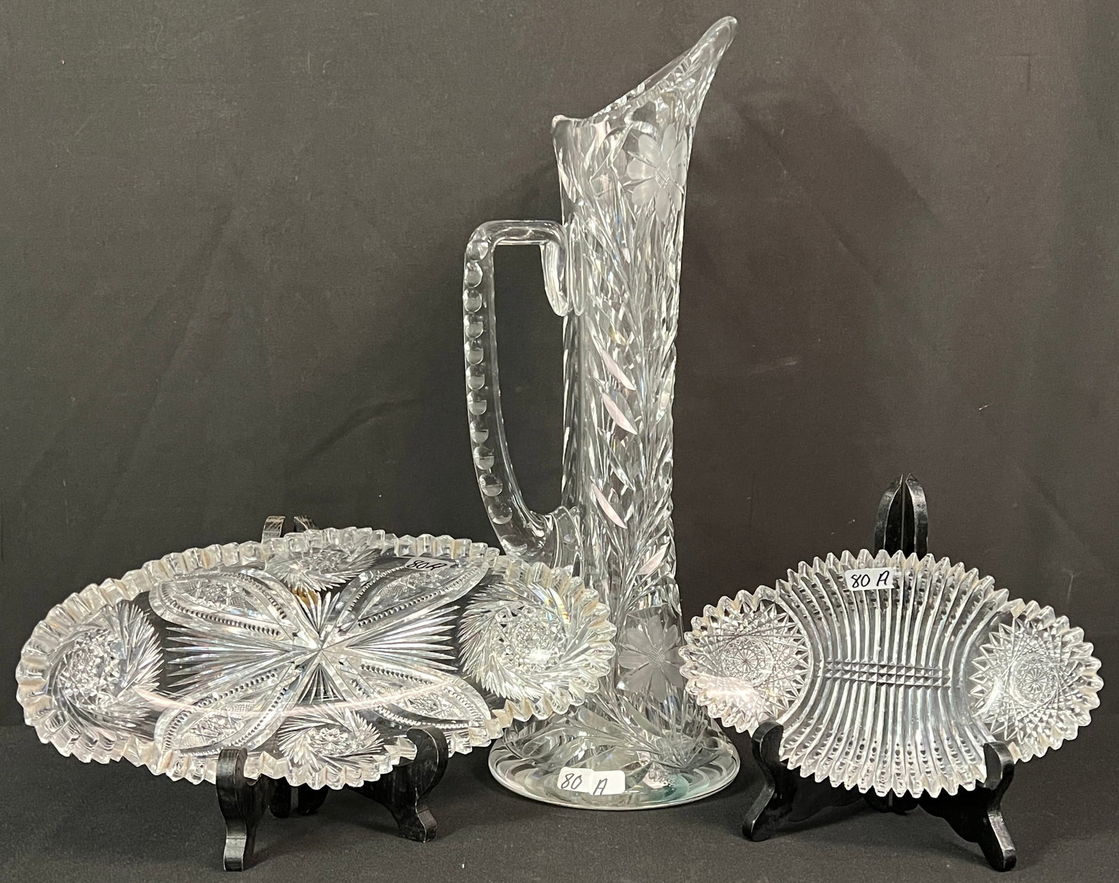 Group of Important Cut Crystal: A group of important cut crystal to include a Victorian elongated floral cut and pressed pitcher that measures 16" tall X 6" round. Along with a brilliant sawtooth, wheel cut and zipper cut relish