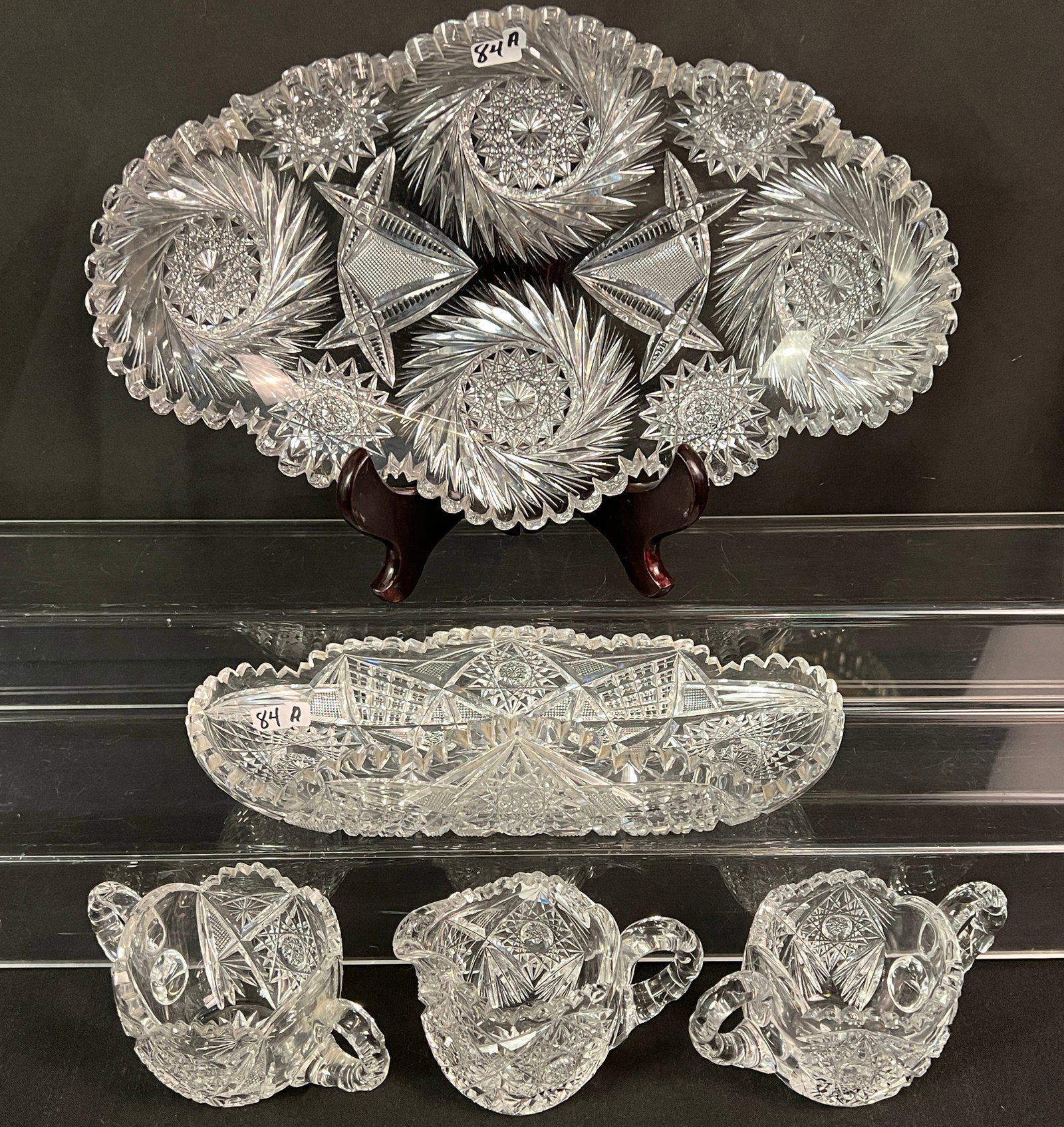 Group of Victorian Brilliant Cut Crystal: A group of Victorian brilliant cut crystal to include a pinwheel star cut and cross hatched huge relish or ice cream server (14" long X 9" across) and a rolled side brilliant and diamond cut relish