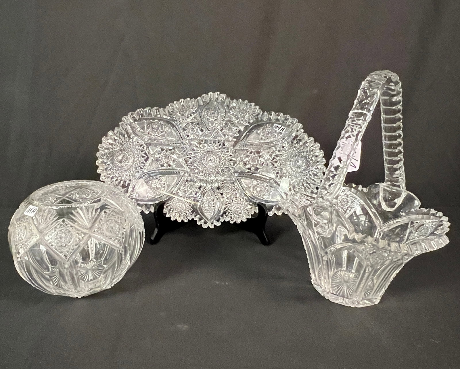 Large Brilliant Cut Serving Dish and More: A group of cut crystal to include a large brilliant cut serving dish with sawtooth edging (14" long X 8" across), a quality cut crystal basket with zipper cut edged and handle (12" tall X 8" long X