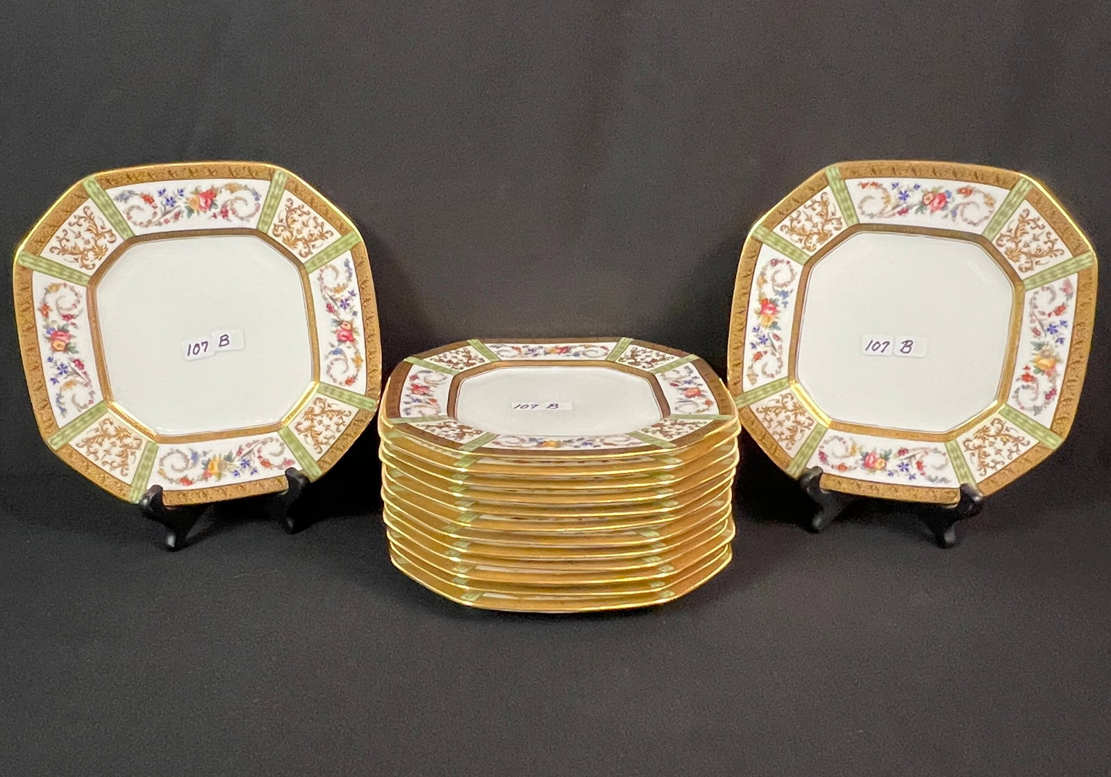 Cauldon Ltd. Gold Trimmed Plates: 14 stunning Cauldon England octagon plates with raised gold leaf and fleur de lis, along with hand-painted garland trims. These fabulously executed plates are in mint condition and measure 8.5" round.