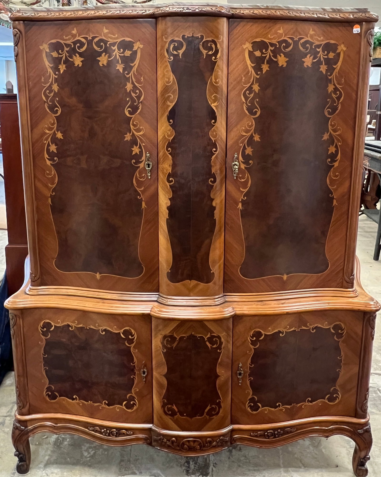 French Style Inlaid Marble Top Liquor Cabinet: A 20th century French style 4 door marble top liquor cabinet that features locking upper and lower doors with inlaid scrollwork, inner black velvet lined shelves, carved cabriole legs and apron and