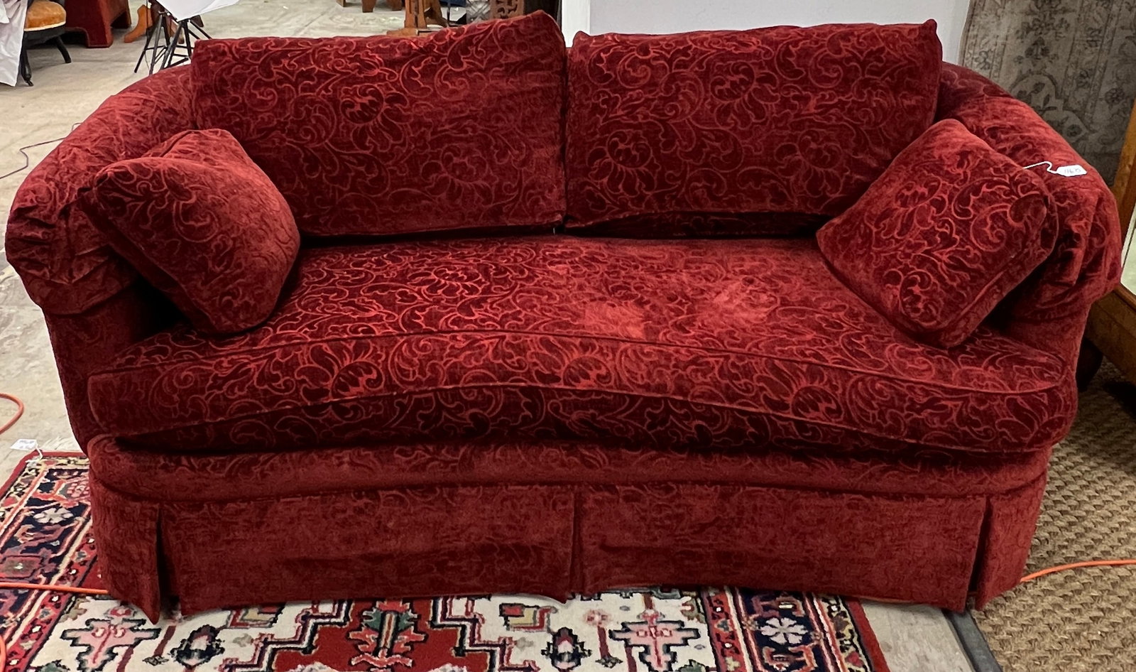 Sherrill Burgundy Sofa: A Sherrill floral cut, burgundy velvet sofa, down filled, in good condition. It measures 31" tall X 74" across X 25" deep.