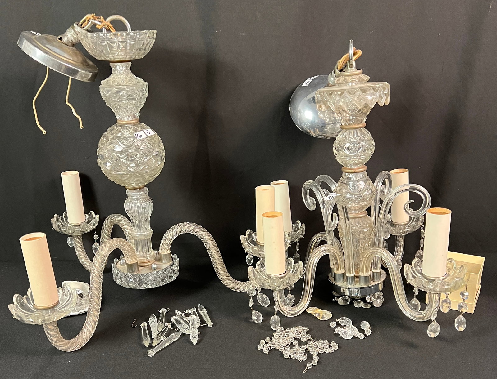 Two Crystal Chandeliers: Two Venetian-style crystal chandeliers. The larger, a 3-arm, has barley twist arms, pressed ball font stem, and crystal drops (19" tall X 19" across) with damage to one of the wax catchers. The smalle