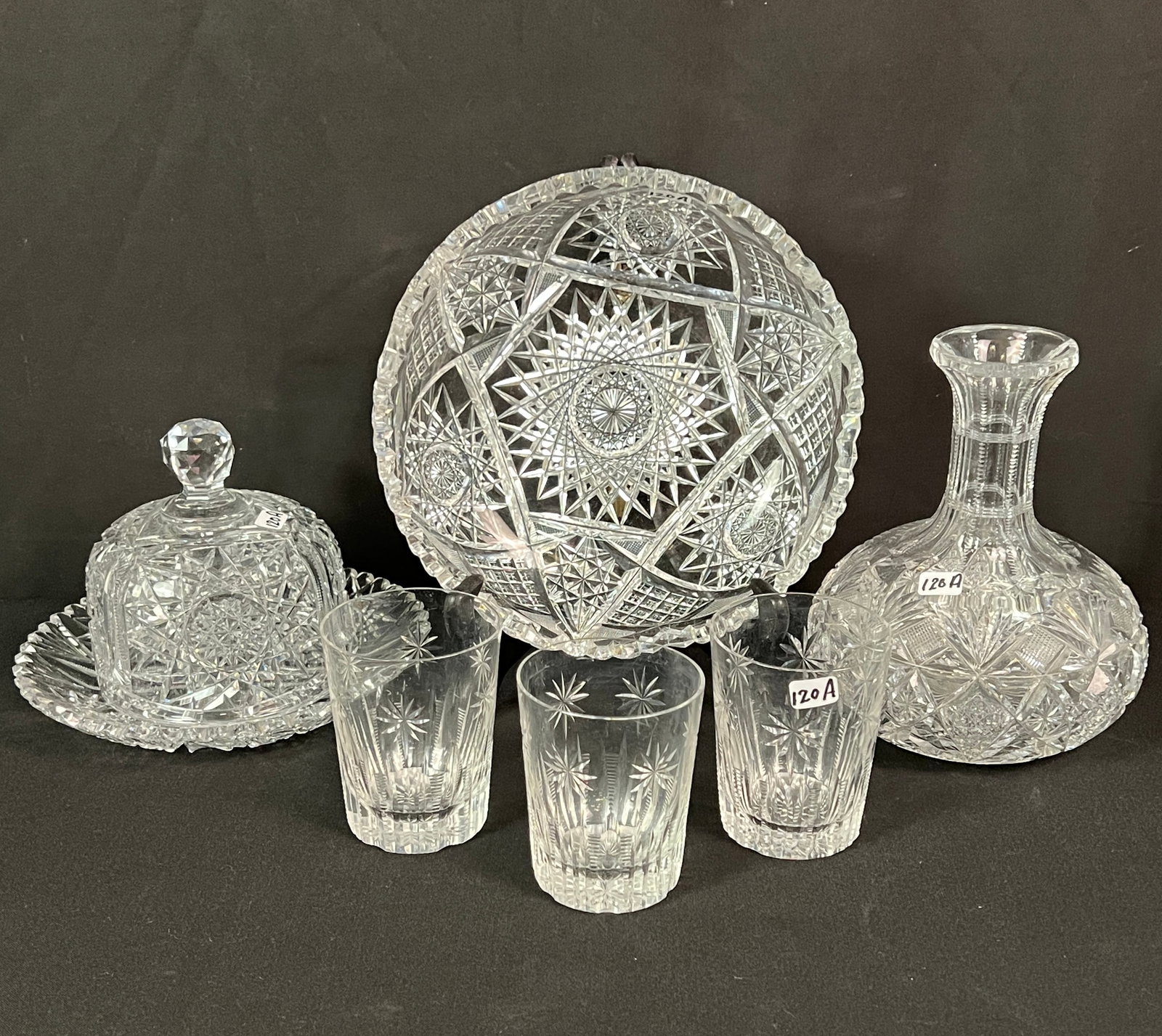 Group of Brilliant Cut Crystal: A group of brilliant cut crystal to include a starburst cut crystal covered butter/cheese (5" tall X 8" round), a bowl with diamond and wheel cut (2.5" tall X 9" round), a vase with fan and diamond cu