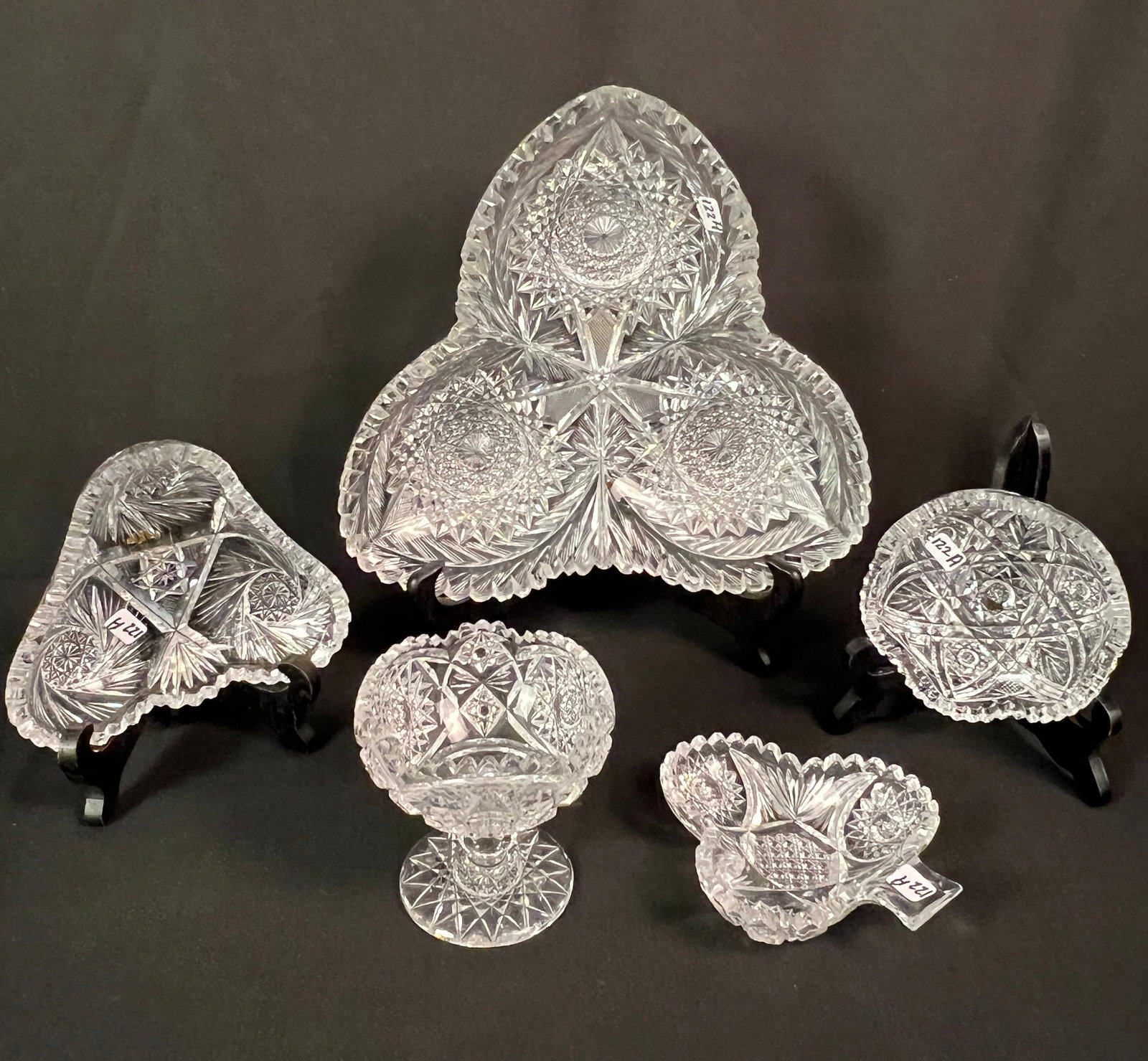 Unusual Brilliant Cut Crystal Lot: An unusual brilliant cut crystal lot to include 3-sided heavily cut serving bowl with sawtooth edging (2.25" tall X 11" diagonal), a smaller version of the same dish (2" tall X 6" diagonal), a club