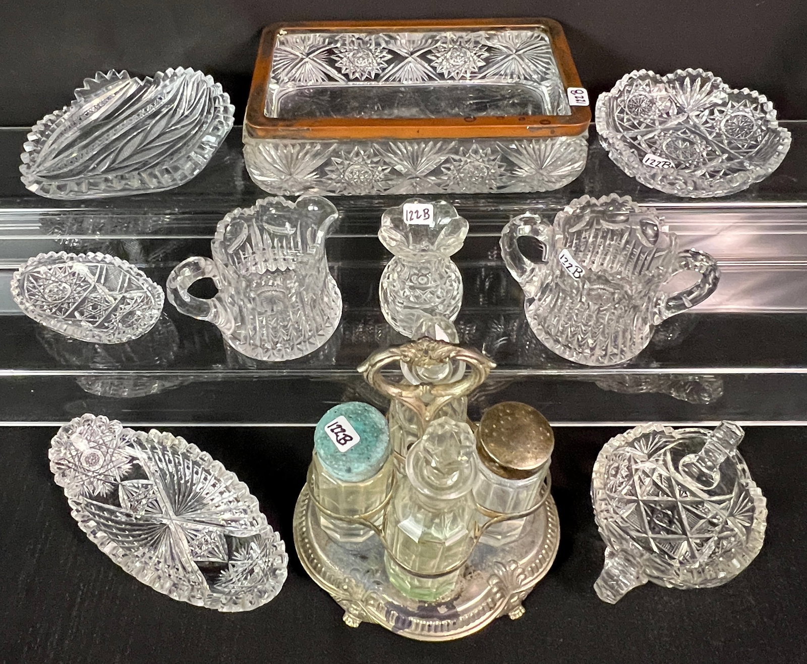 Large Group of Brilliant Cut Crystal: A large group of brilliant cut crystal to include a pinwheel cut desk organizer, a double handled nappy, a cut crystal leaf dish, round crystal candy bowl, a bullseye and zipper cut creamer and