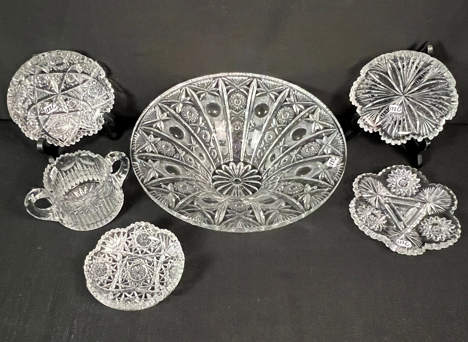 Group of Cut Crystal: A group of cut crystal to include a large wheel cut crystal center bowl (3.5" tall X 12" round), 4 shallow bowls and a double handled sugar bowl. All in excellent condition.