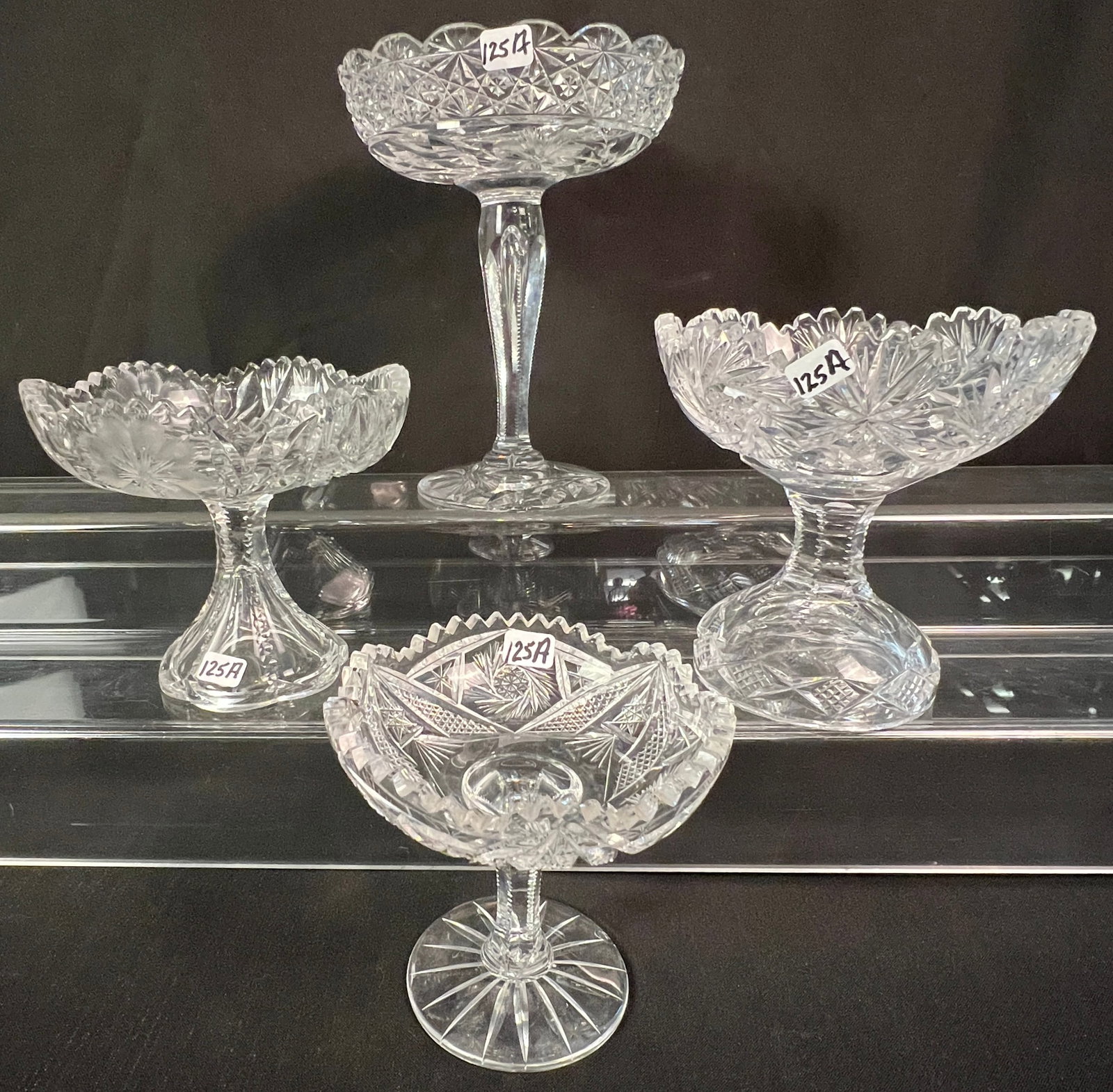 Group of Cut Crystal: A group of cut crystal to include 4 graduated brilliant and floral cut crystal compotes the (largest has a controlled bubble in its stem). All in excellent condition.
