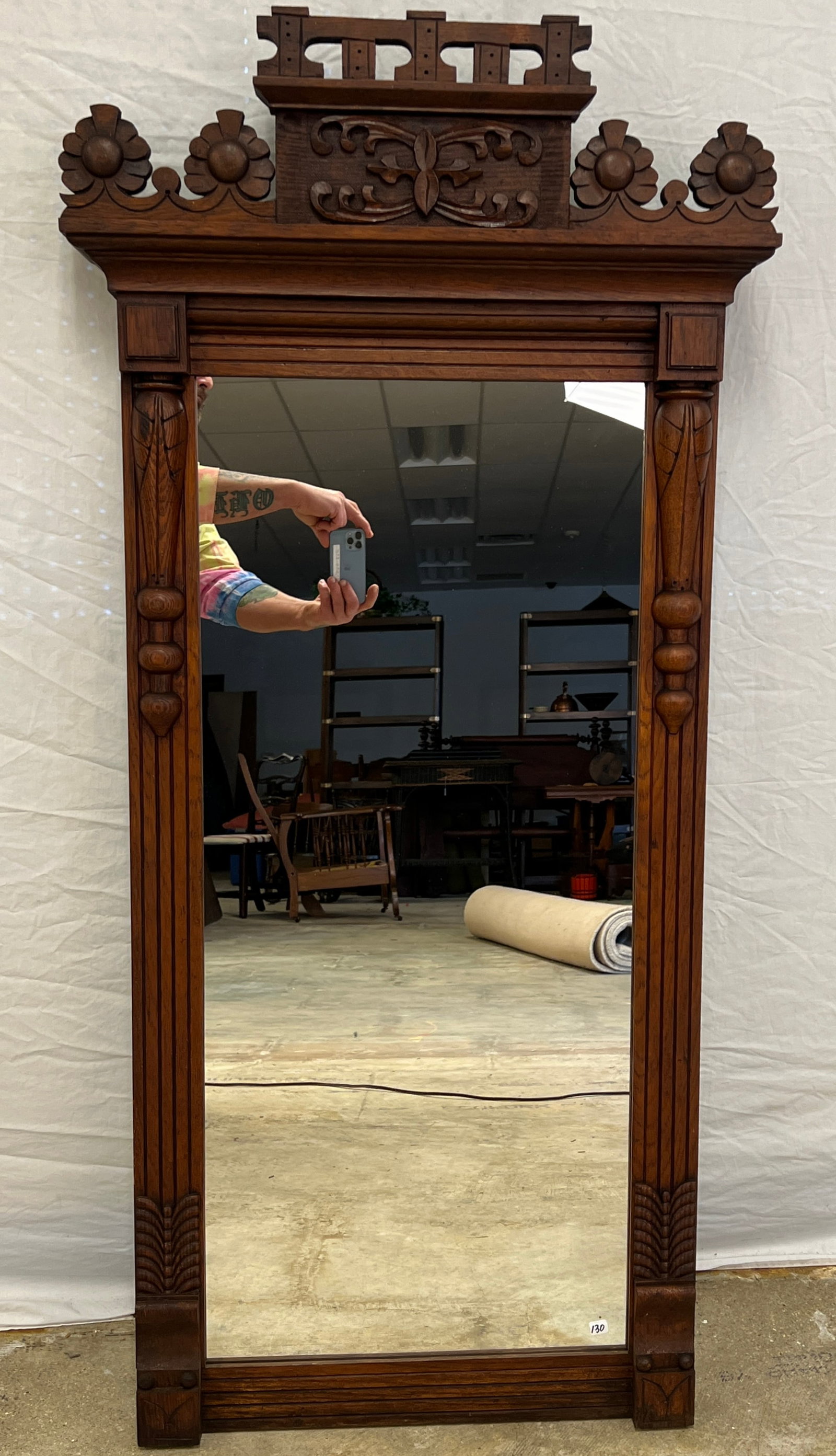 Victorian Floral Carved Hall Mirror, c.1880s: A fancy Victorian carved mahogany hall mirror that features floral crown, with hand carved scrolled central medallion, pillared sides, c.1880s. In excellent condition it measures 54.5" tall X 26" acro