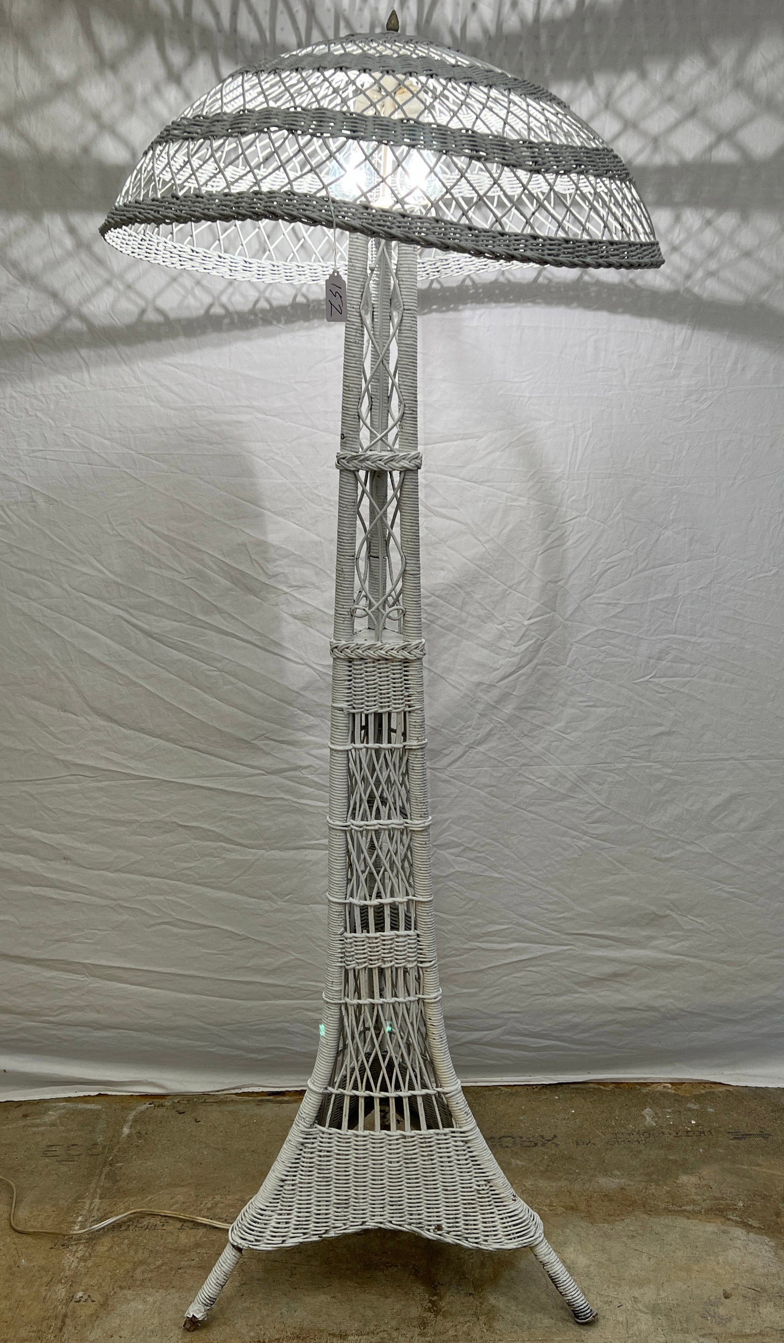 Eiffel Tower Wicker Floor Lamp c.1900: An Eiffel Tower shaped wicker floor lamp c.1900 with original shade that measures 70" tall X 27" across the shade in very good condition. It features a 2 socket system with pull chain switches.
