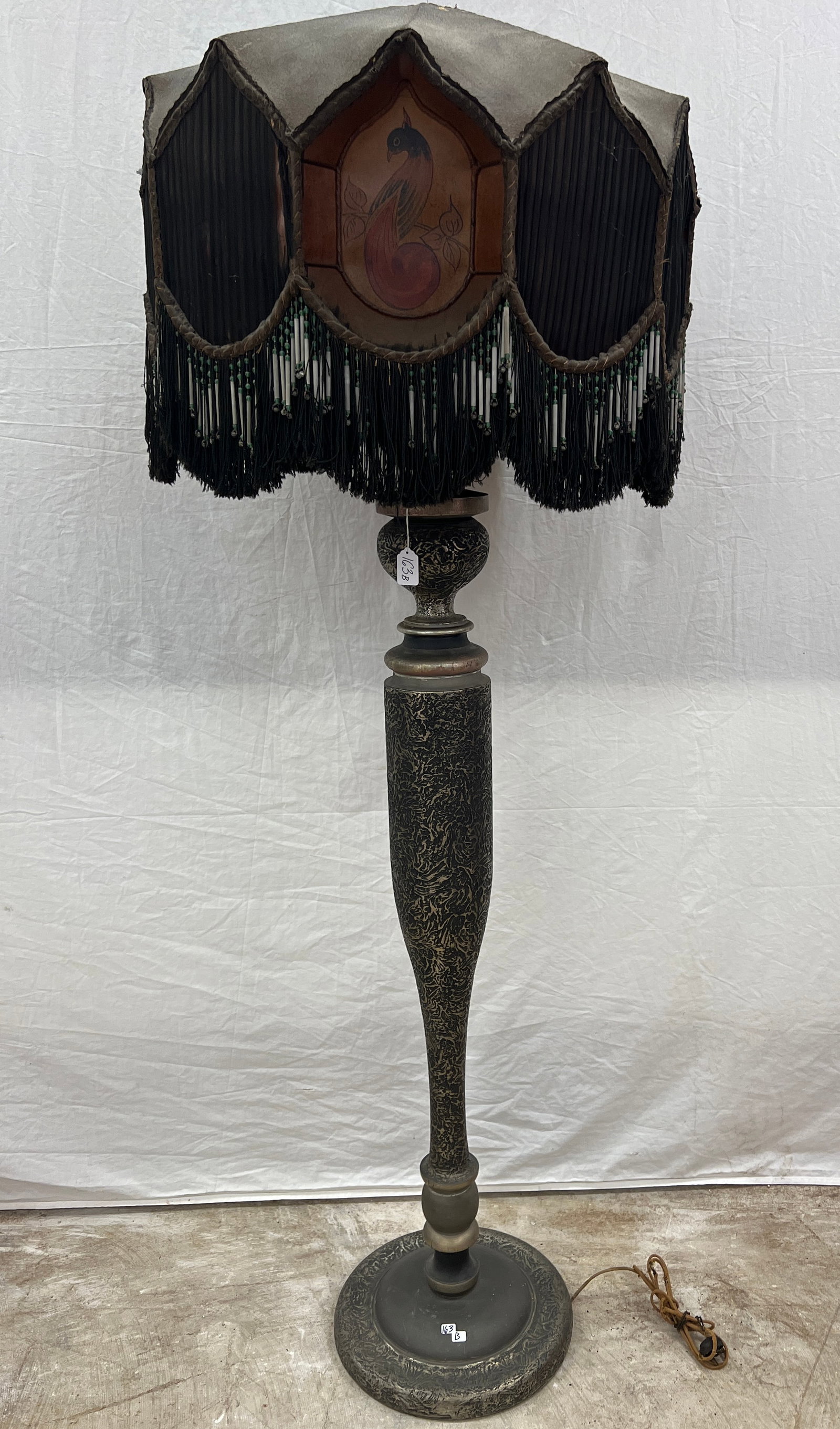 1900s Floor Lamp w/ Fancy Beaded Shade: A turn of the century beaded and fringed outrageous shade with inset hand painted parchment bird and floral panels and bulbous base. Minor losses to shade noted and needs rewiring, but truly an