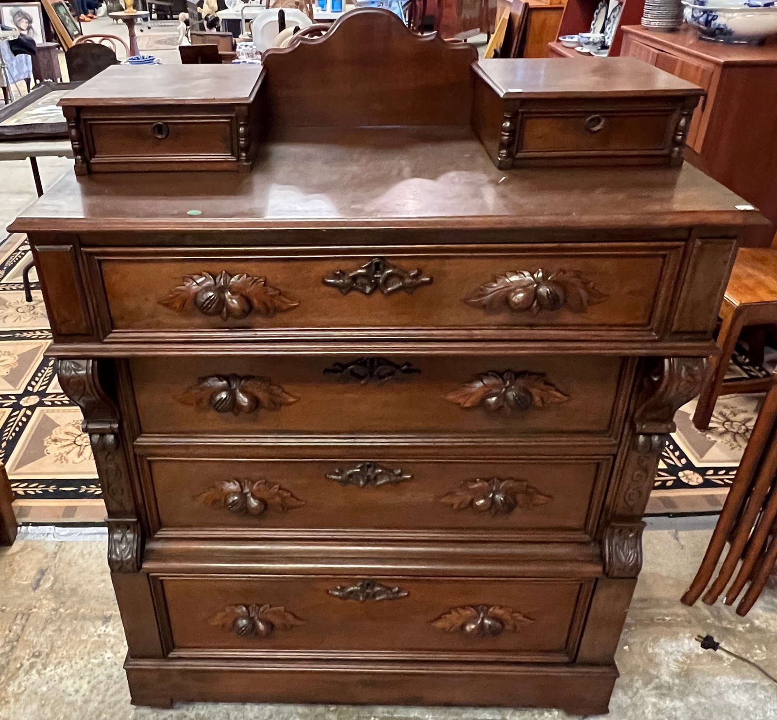 Victorian Walnut Hanky Box Dresser: A walnut extra grade hanky box dresser with fruit and nut carved handles, carved key escutcheons, 4 drawers. In excellent original finish, dresser measures 52" tall X 40" across X 20" deep.