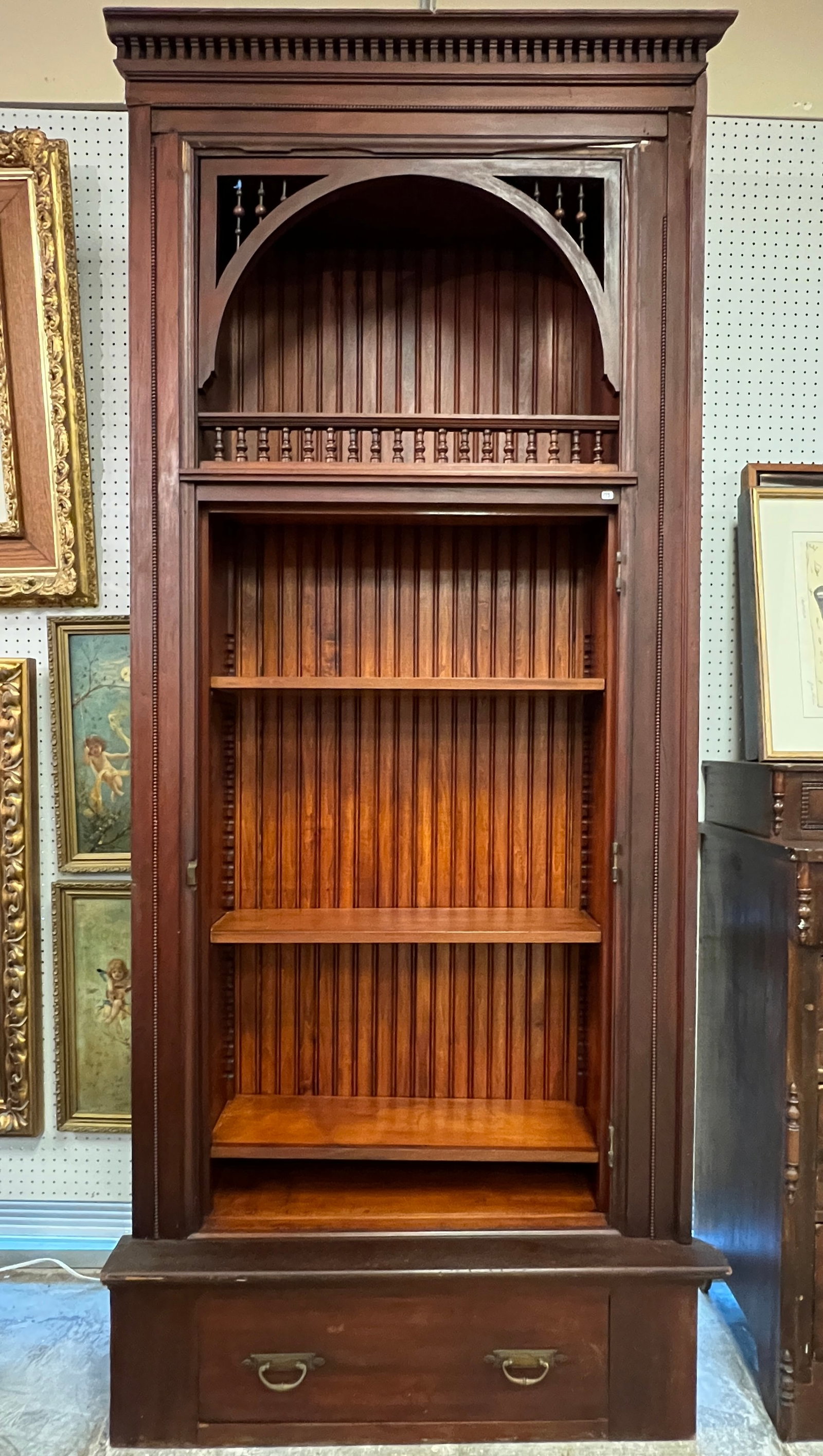 Victorian Cherry Finish Built-in Cabinet: A Victorian built in cabinet with shelves which features a spindle gallery, shelves, bead work and stick and ball detailing, wainscoting back and single drawer base. Missing door, some beadwork, damag