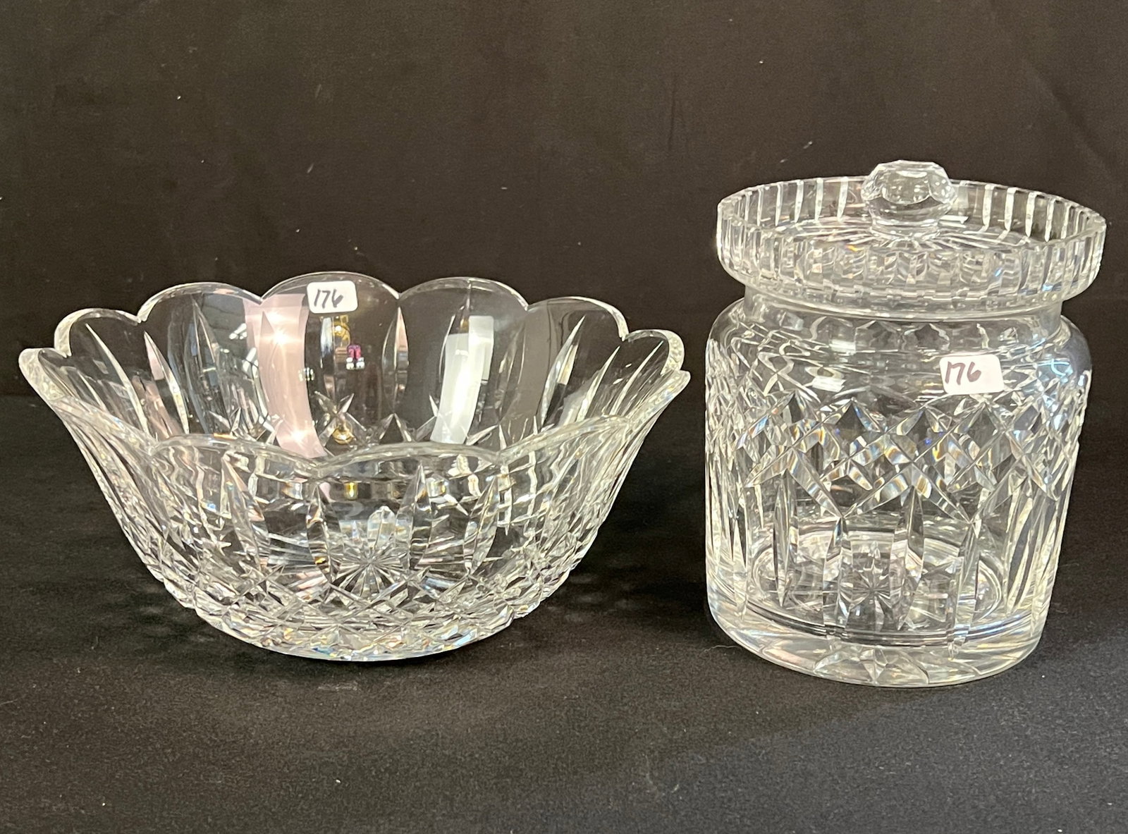 Waterford Bowl and Lidded Jar: Two pieces of Waterford "Lismore" pattern crystal to include a lidded biscuit jar that measures 6" tall by 5.5"across. The fluted bowl measures 4" tall by 9" across.