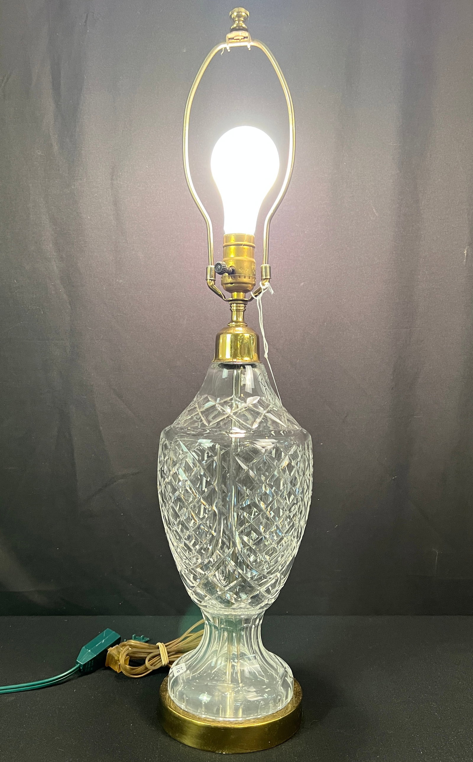 Waterford Lamp: A Waterford crystal table lamp base has an acid etched, top brass cap of lamp has separation noted. the lamp measures 28" from base to finial.