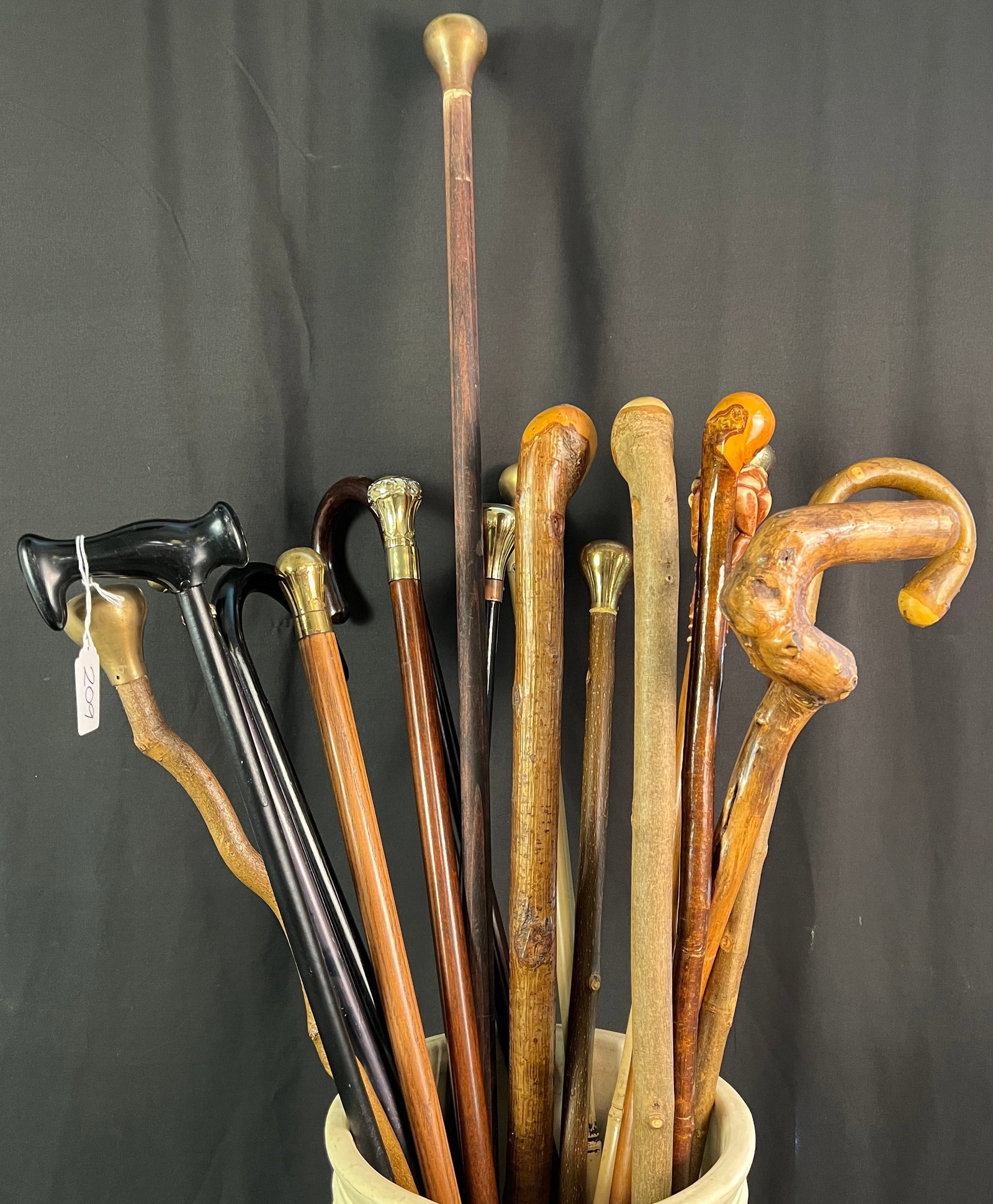 Group of Assorted Walking Canes: A group of 17 walking canes to include shillelagh, brass head, carved and more. All in good condition.