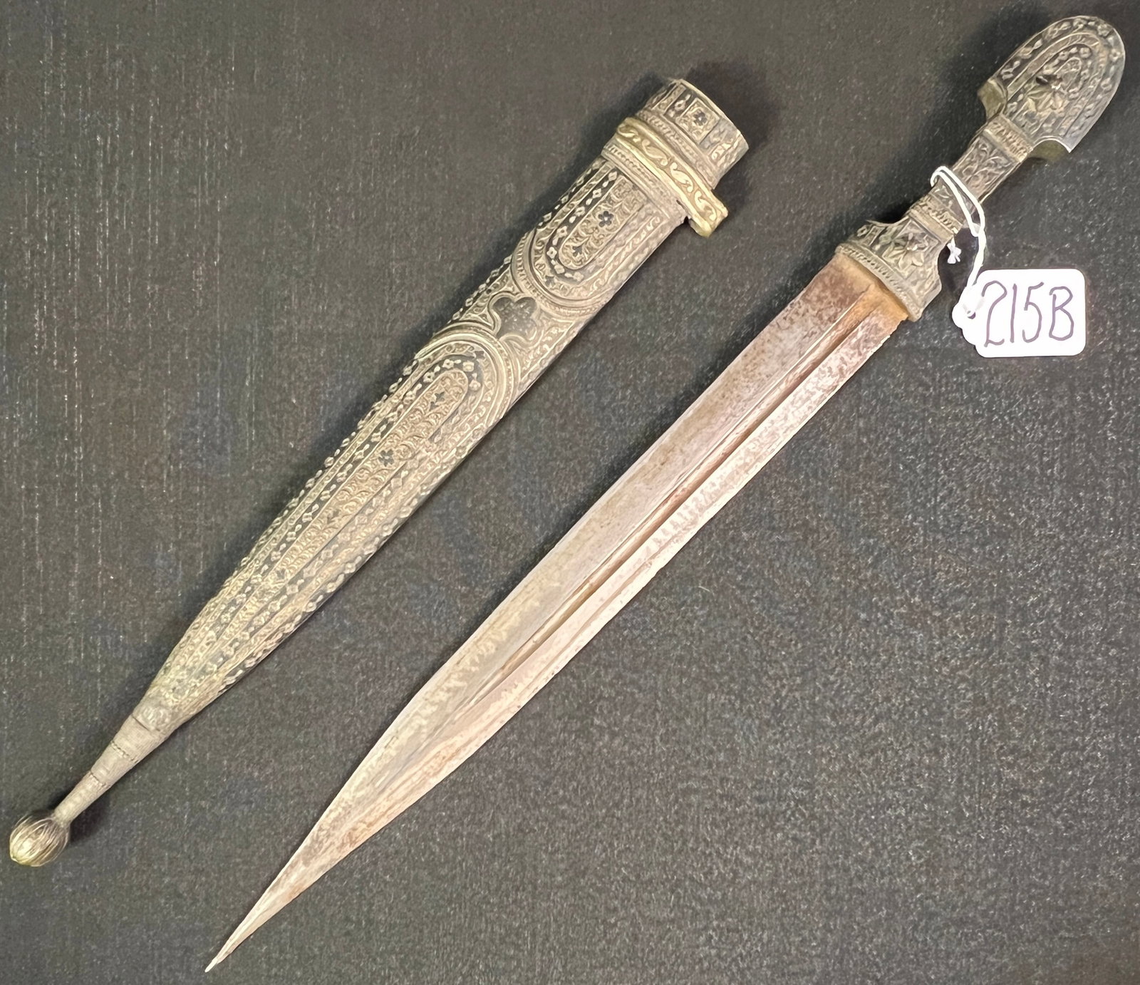 18th Century Middle Eastern Silver Dagger: An elaborately chased early 18th century Middle Eastern dagger and sheath, hand forged and hand decorated. This early dagger is in fair condition, needs to be cleaned. It measures 17.5" long.