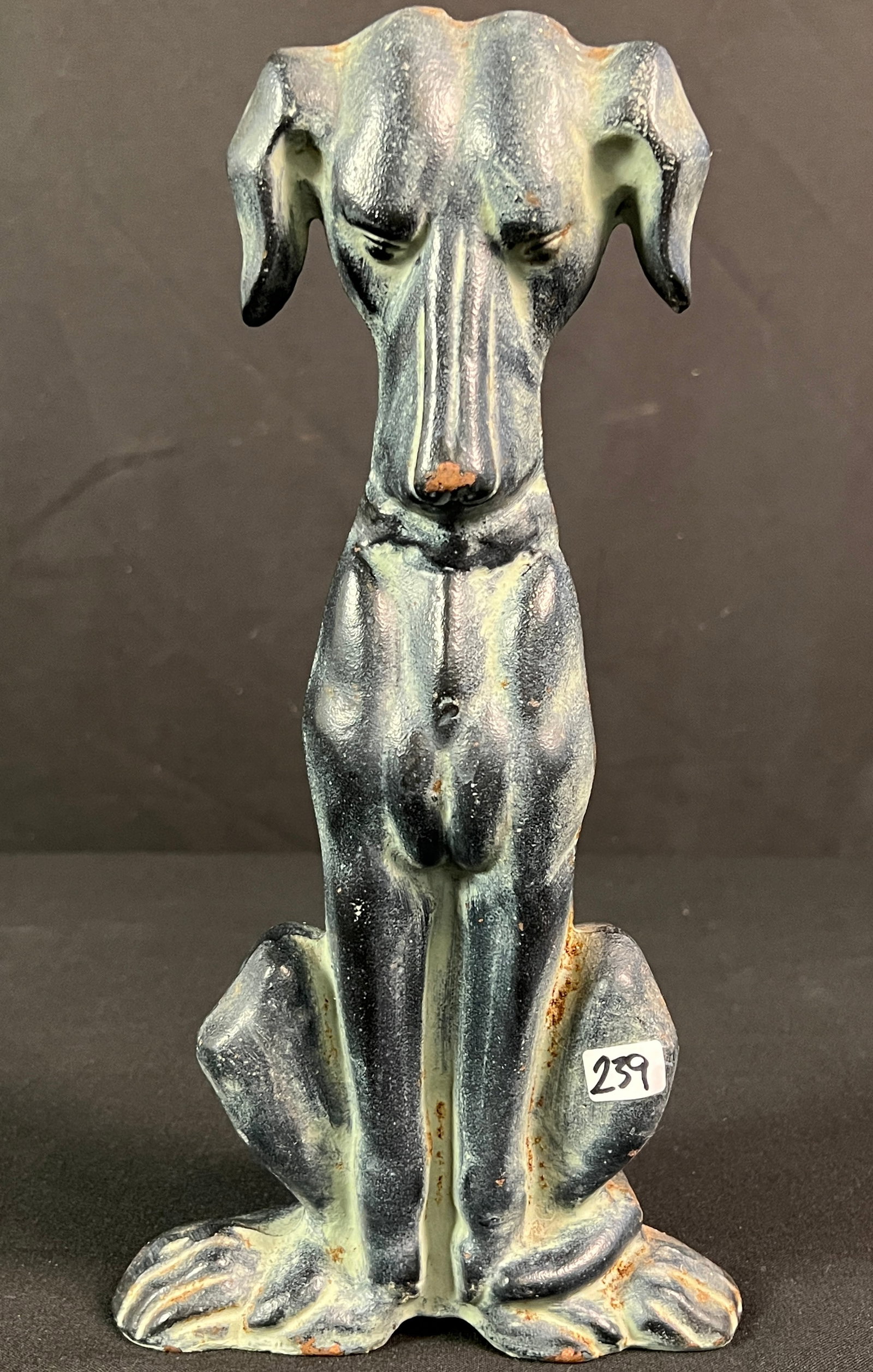 Art Deco Dog Doorstop: An Art Deco cast iron with bronze glaze doorstop in the shape of the dog, with foundry mark and registry on back. Nice patina, it measures 12" tall X 6" across X 3.5" deep.