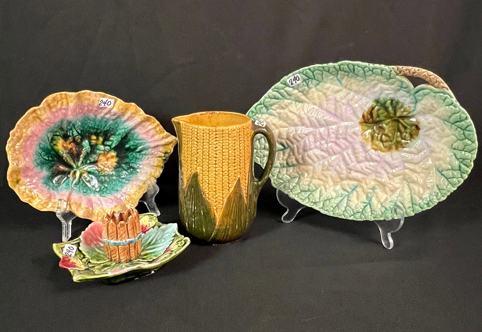 Majolica Serving Pieces and More: 4 pieces of early Majolica to include a corn pitcher(6.5" tall X 5" across), large handled leaf platter(2" tall X 8" across X 11" long), small multicolored leaf serving dish signed Etruscan Majolica
