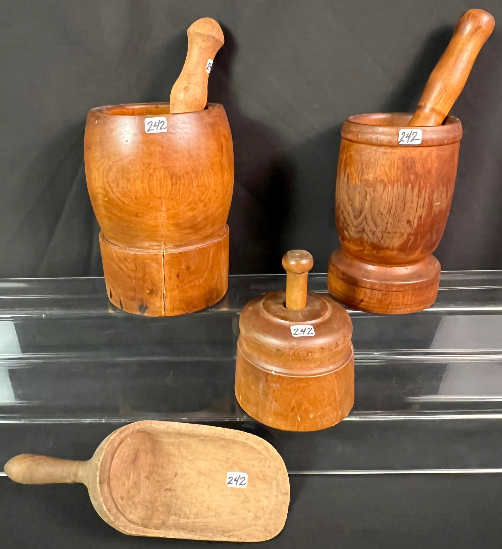 Group of Antique Wooden Ware, Pre-Civil War: A group of antique wooden ware, pre-Civil War, to include 2 mortar and pestles (larger 8.5" tall X 5" around & smaller 7.5" tall X 4" around), a butter press (6" tall X 4.5" around) and a wood scoop