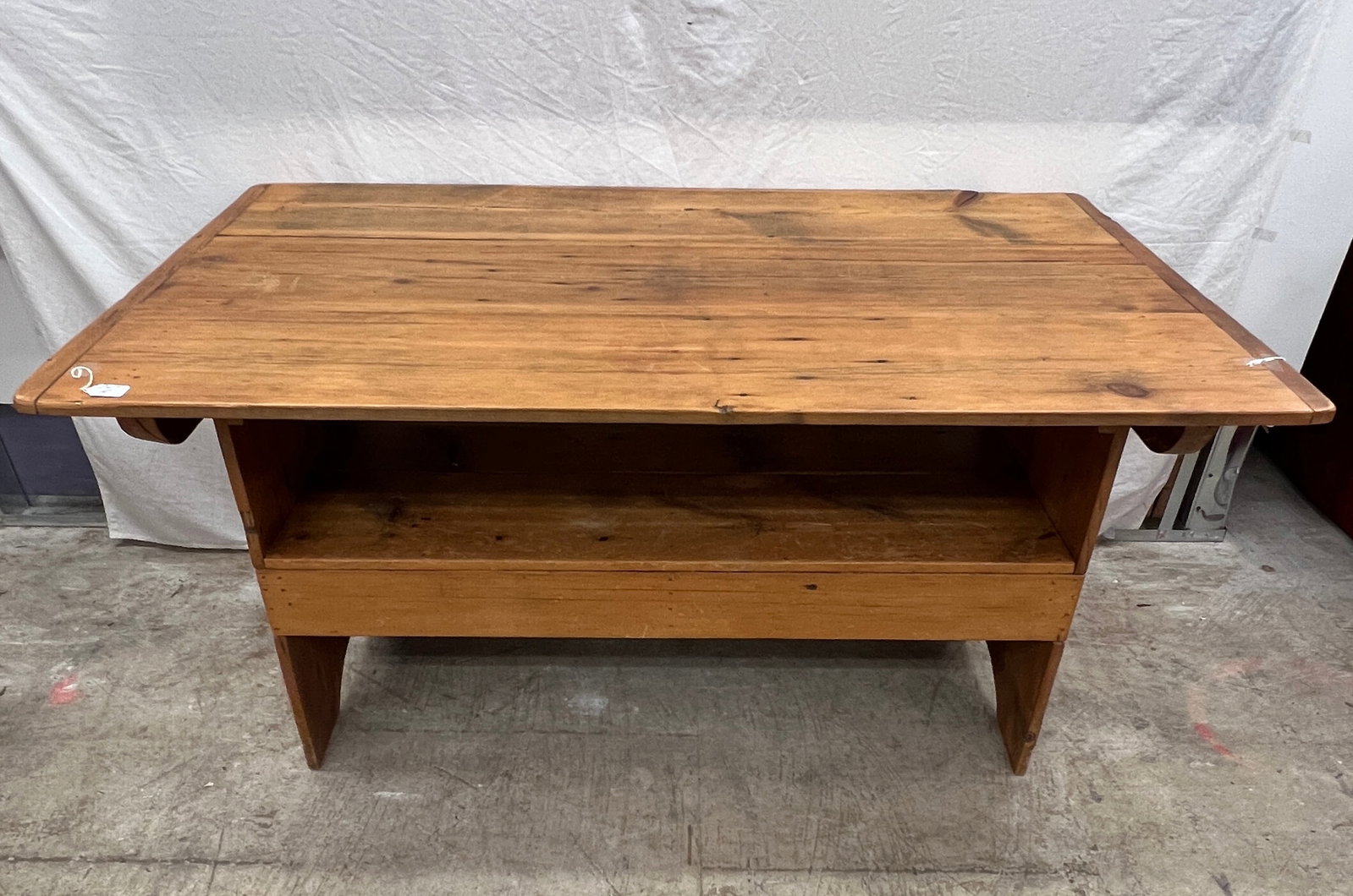 Flip Top Harvest Table: A flip top kitchen harvest table with bread board sides, that flips up into a bench. In good condition with some age, it measures 30" tall X 59.5" long X 36" deep.