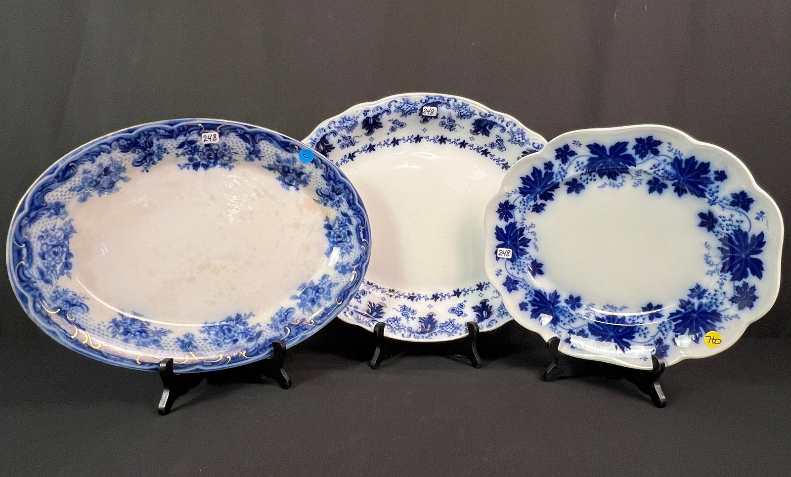 3 Flow Blue Platters: 3 flow blue platters, the first the Vinranka pattern by Gefle Sweden, featuring grape vines (measures 13" long X 11" across with no chips, in good condition). The next is a Bourne & Leigh platter in t