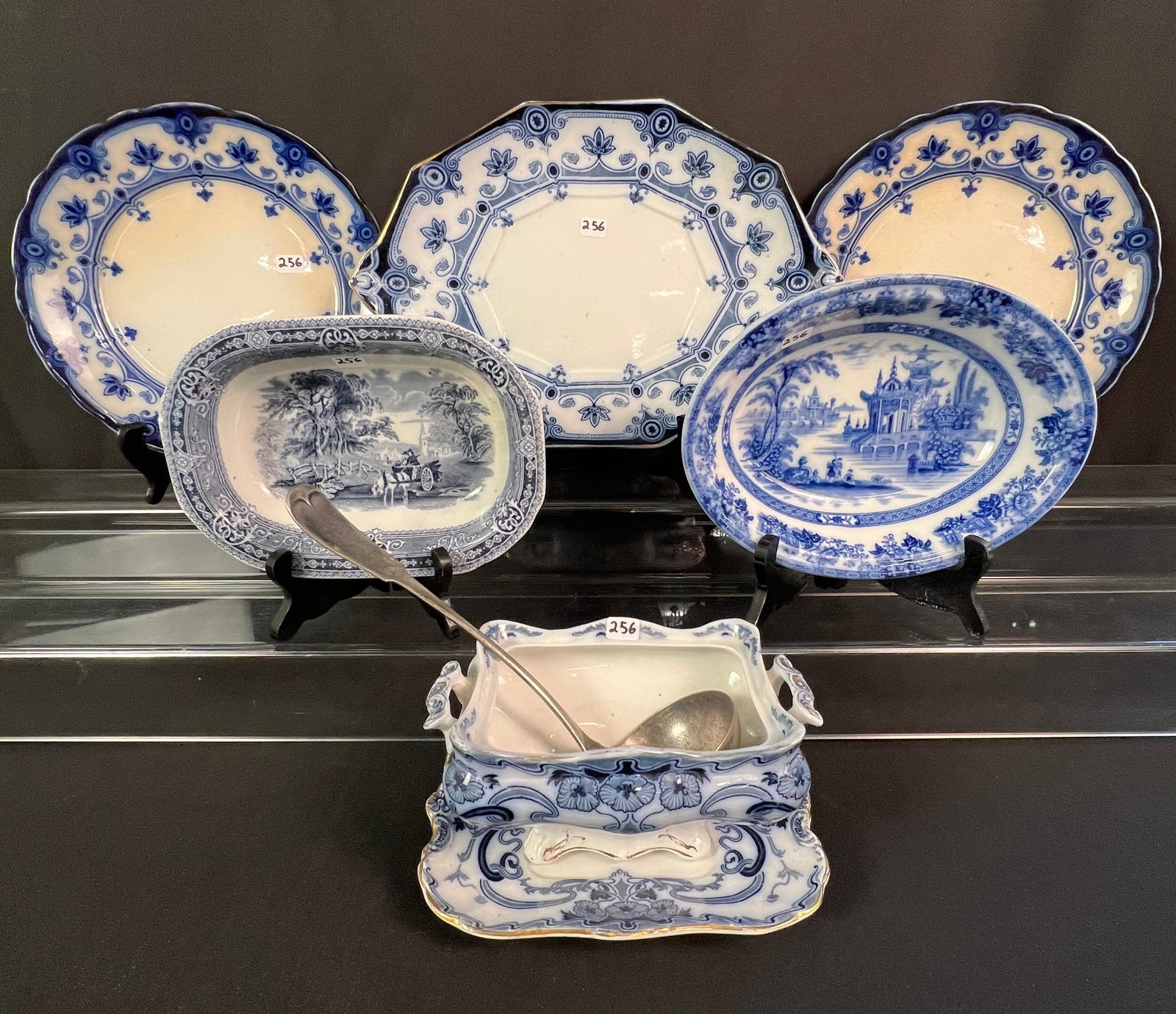Group of Flow Blue to Include Platter, Plates, Bowls, and Gravy Boat: A group of Flow Blue to include a platter and 2 plates in the "Dudley" pattern by F. and Sons Burslen (Platter measures 13.5 by 9.25, plates measure 9.5" across), a bowl in the "Woodland" [pattern by