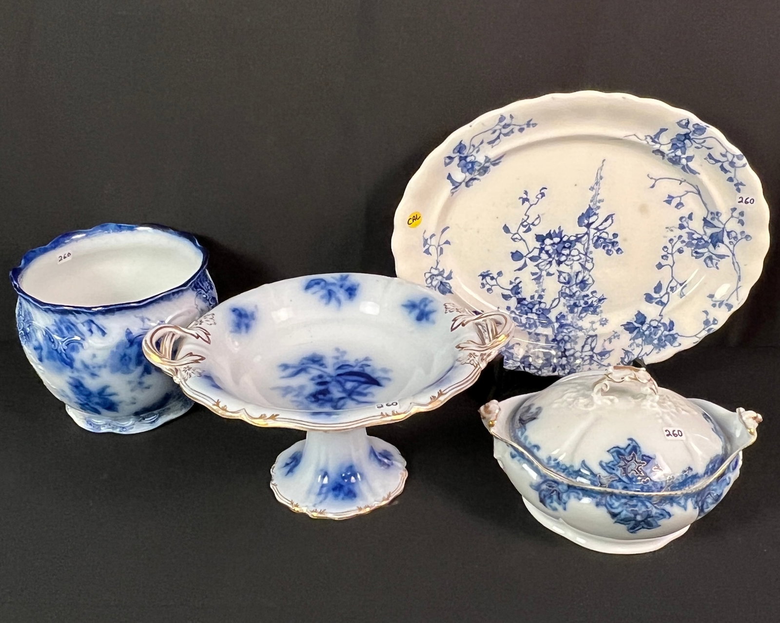 Flow Blue Platter, Tureen, Planter, and Compote: A group of Flow Blue including a platter in the "Kew" pattern by Doulton (measures 15"long by 12" across), a covered soup tureen by J.P.L. France (measures 6.25" tall by 10.25" across), a planter in