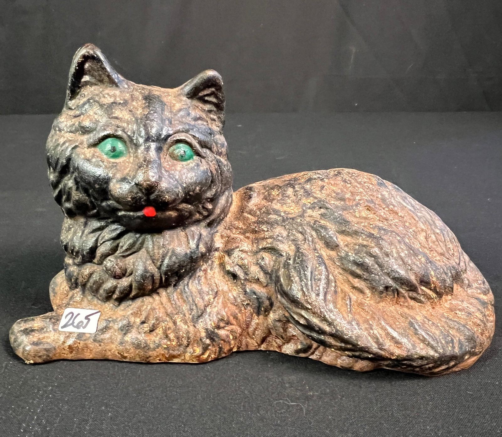 Cast Iron Sitting Cat Door Stop: A cast iron painted doorstop of a black cat with green eyes. Some age rust noted, it measures 6" tall X 11" across.