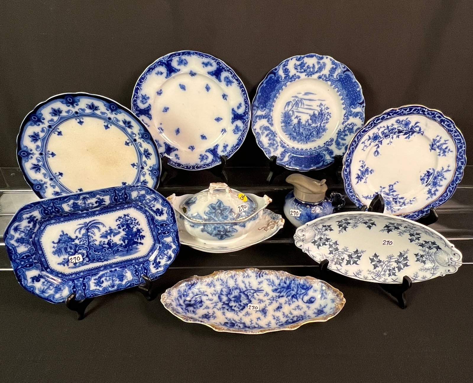 Large Group of Flow Blue: A large group of flow blue to include covered saucer server with undertray, two relishes, small platter, 4 plates and a cream pitcher. All in good condition.