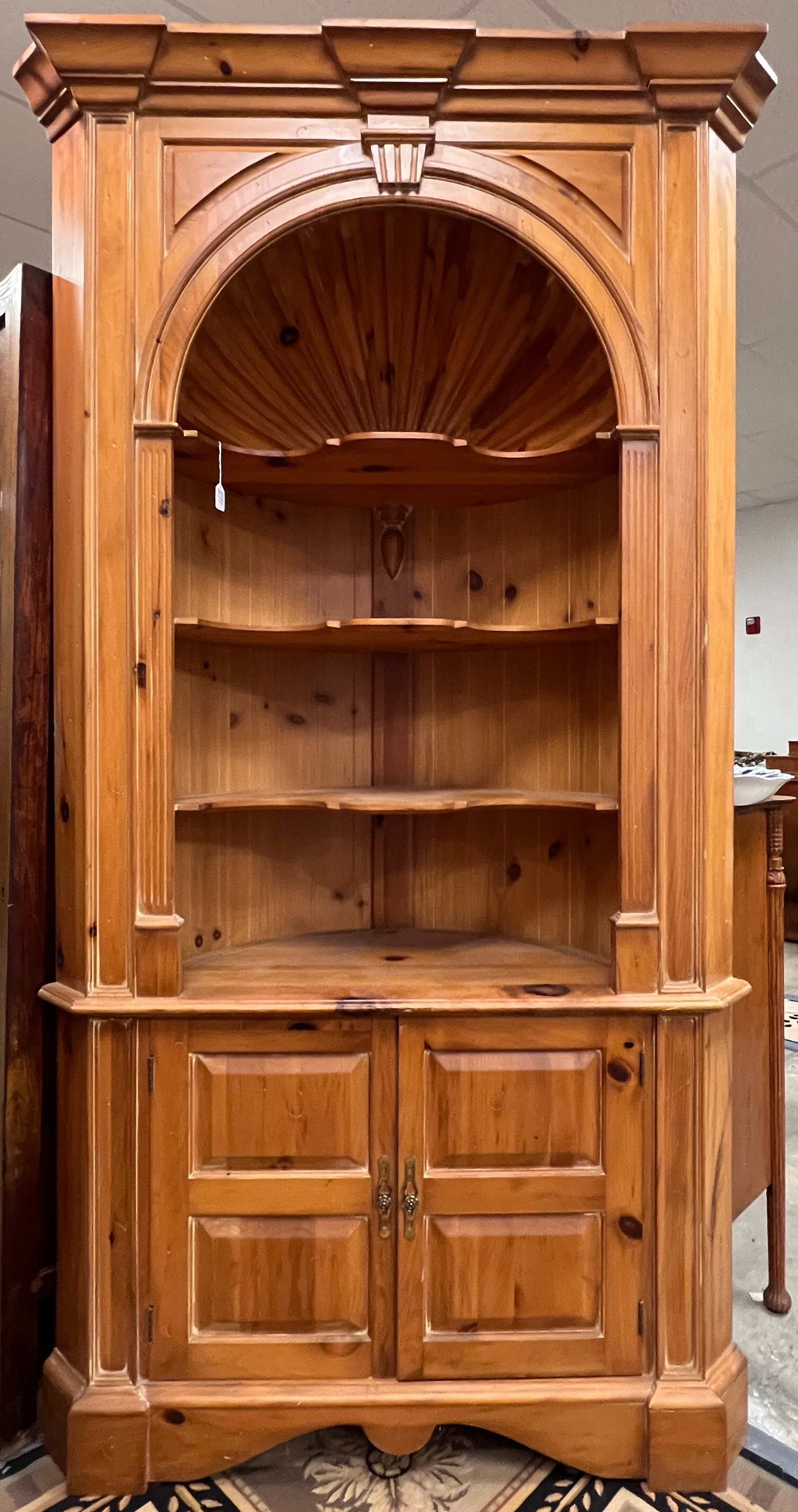 Harden Pine Corner Cupboard: A Harden pine colonial shell-carved corner cupboard with chamfered panels and scalloped shelves. In good, original finish. It measures 86" tall X 46" across X 19" deep.