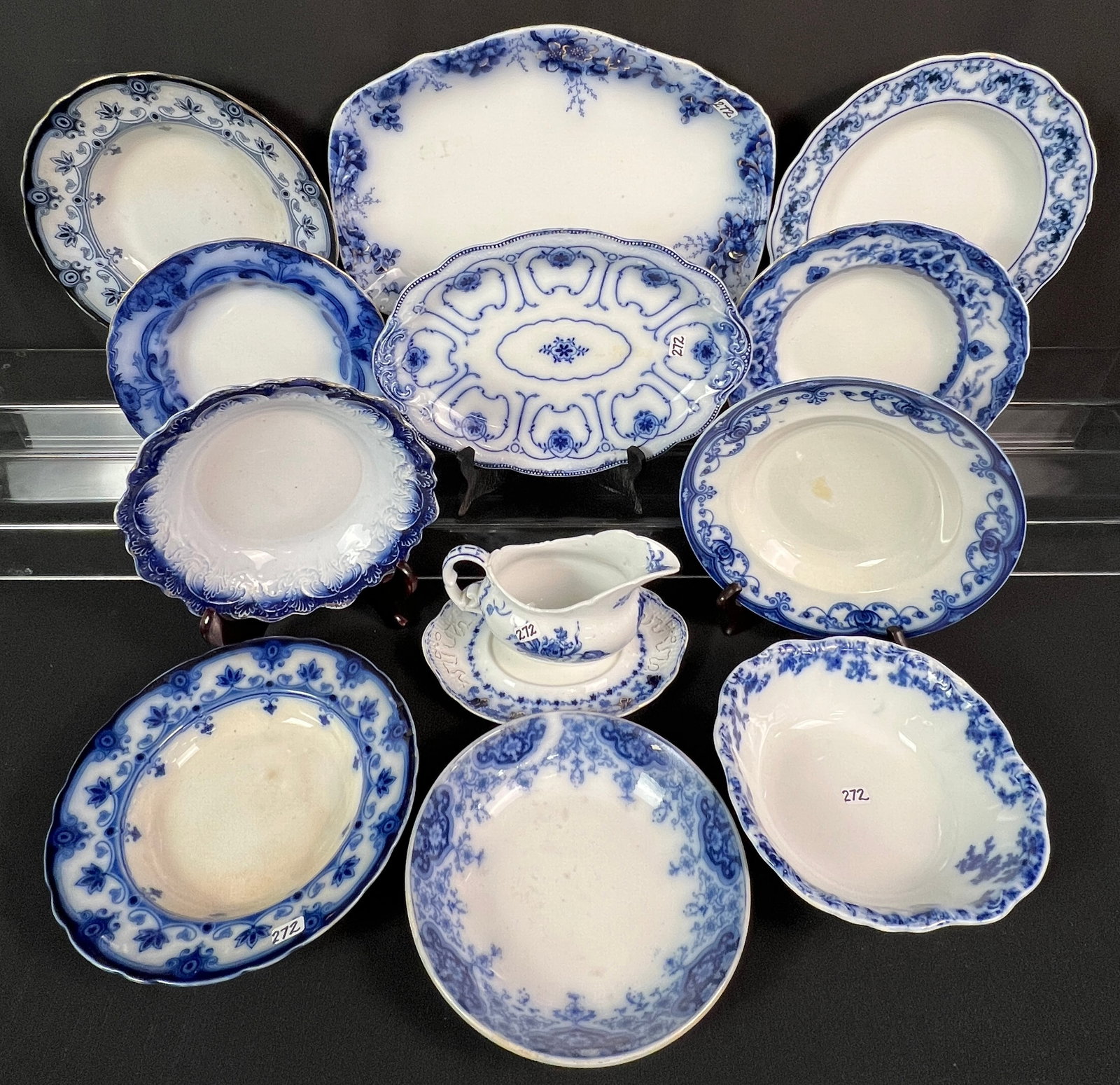 Large group of Flow Blue: Large group of flow blue to include 2 platters, open vegetable bowl, gravy boat, underplate, and 8 soup bowls. All by different manufacturers, all in good condition.