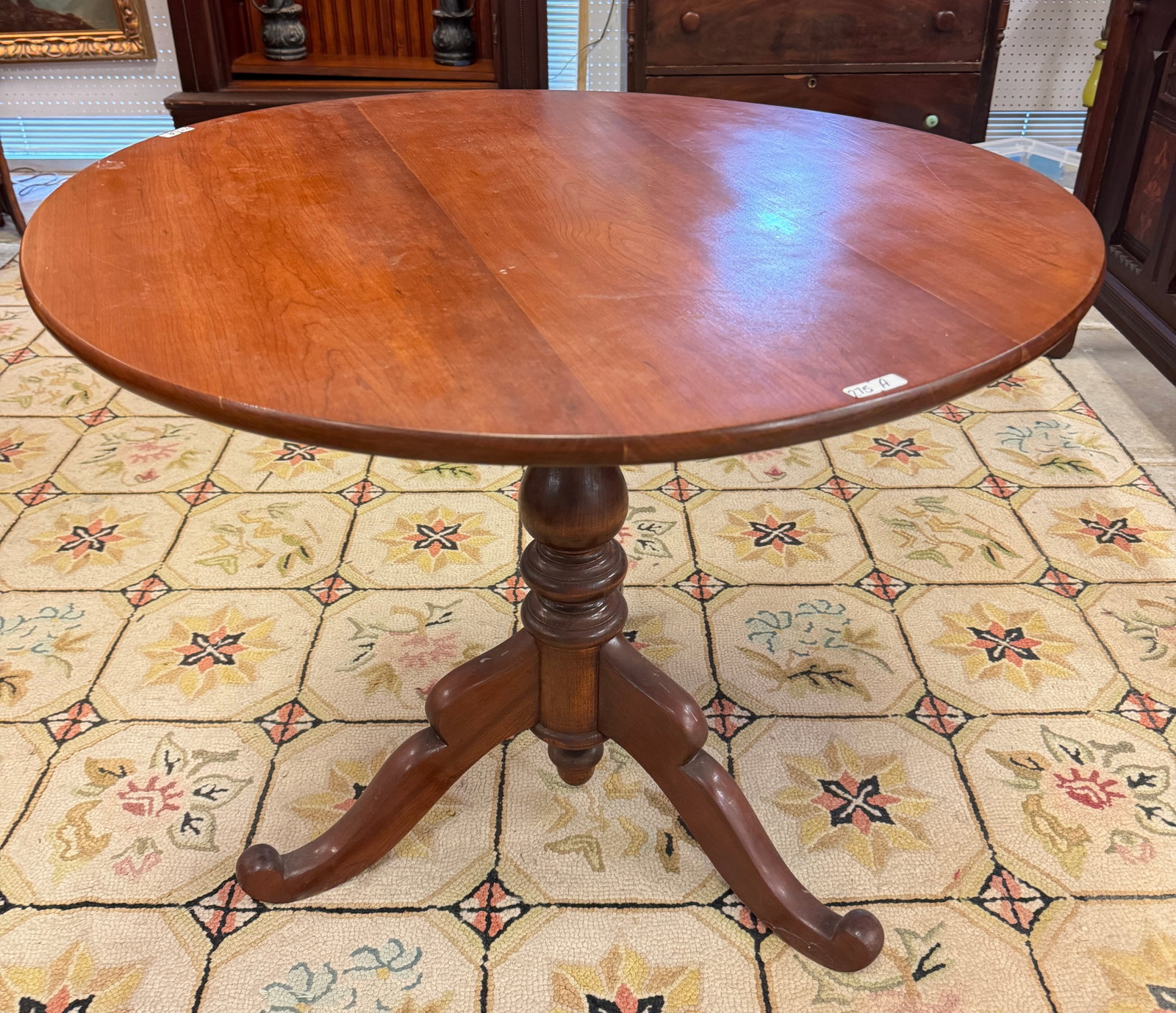 Oval Cherry Country Tilt Top Tea Table: An 1830s/40s slave-foot, turn post cherry tilt top tea table. In excellent house ready condition, it measures 29" tall X 34" round.