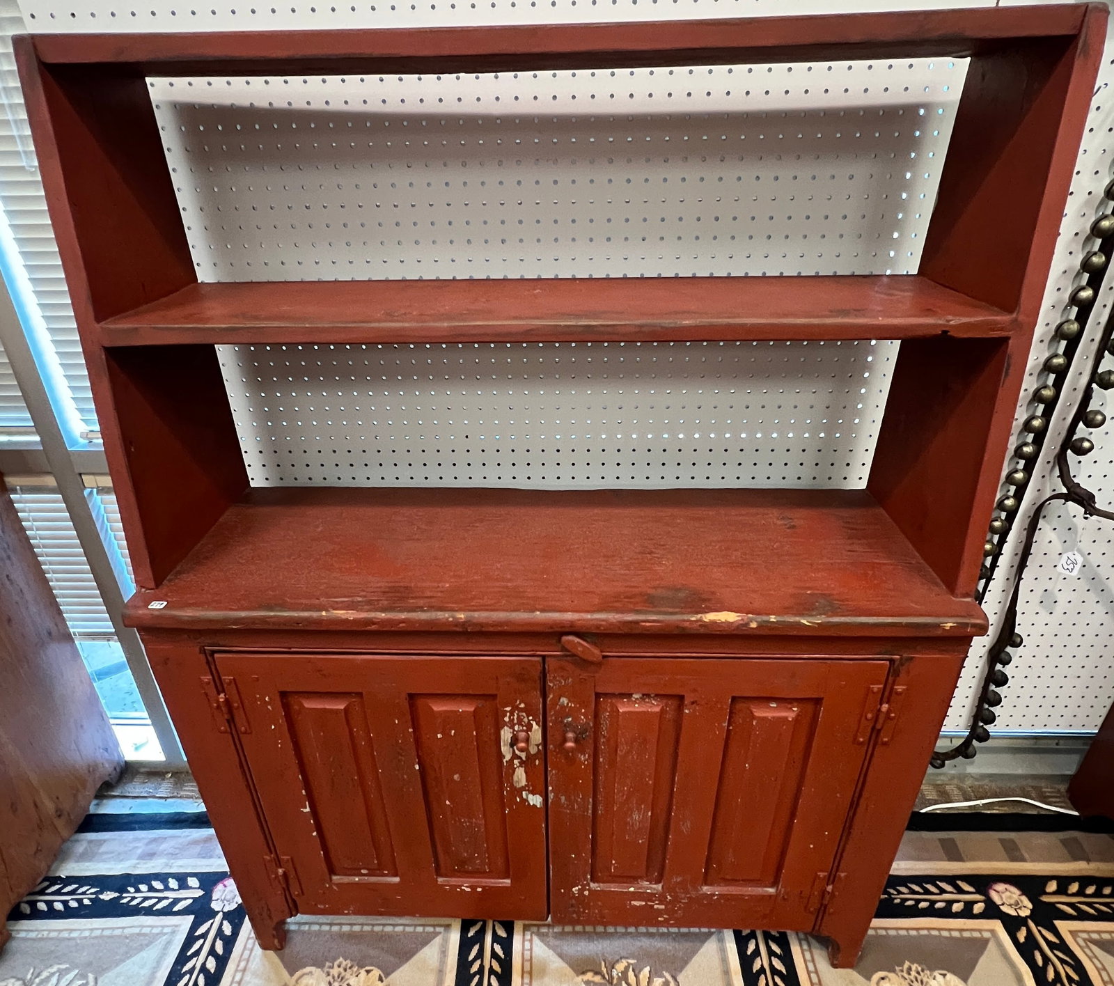 18th Century Painted Step Back Cupboard: An early American Step back double door cabinet with original red paint that features original hardware, butterfly lower doors, and 2 upper shelves in very good condition. It measures 55" tall X 42"