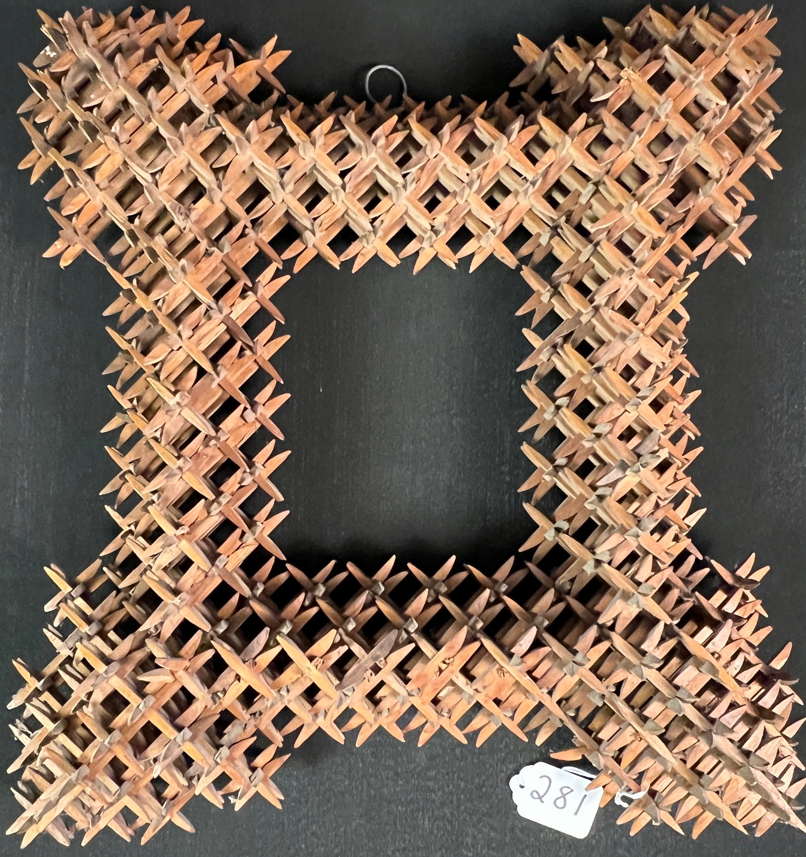Crown of Thorns Tramp Art Frame: An outstanding and intricately made crown of thorns tramp art frame. This unique piece of folk art is painstakingly made from carved pieces of wood that are assembled into starbursts. It dates to the 
