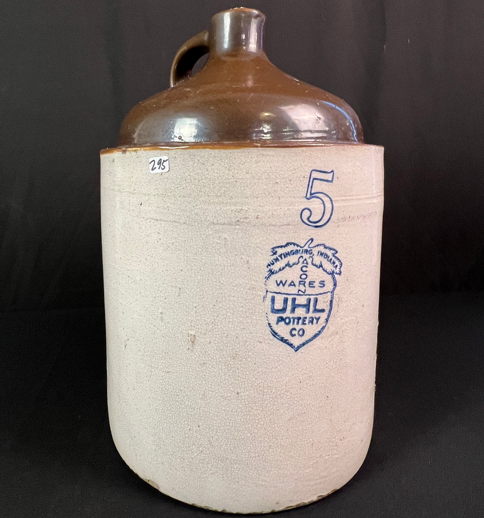 Uhl Pottery 5 Gallon Acorn Ware Stoneware Jug C.1908-1920's: A UHL Pottery Co. Acorn ware two tone 5 gallon stoneware jug c.1908-1920's manufactured in Huntington, Indiana in good condition. Very minor chips noted on rim. It measures 19" tall X 13" across.