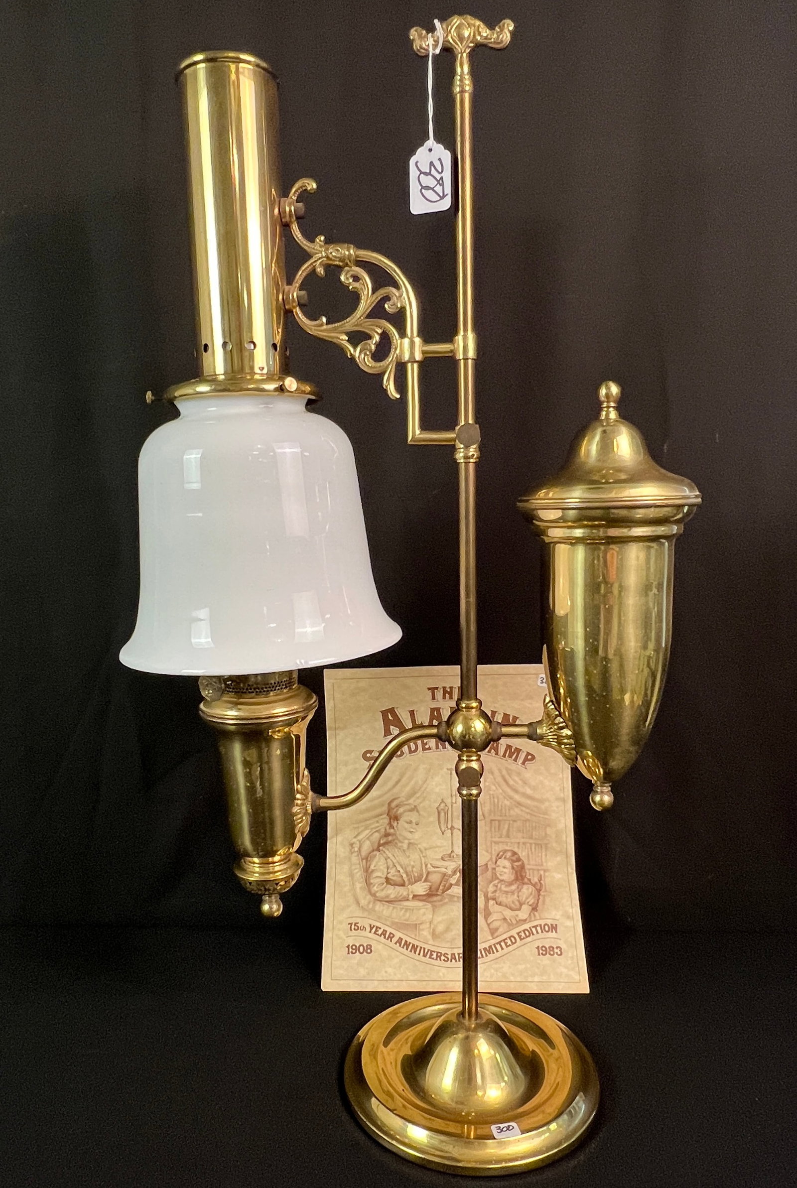 Aladdin Student Lamp 75th anniversary C.1983: A working Aladdin Student Lamp 75th Anniversary c.1983 that features a milk glass shade, brass body, and documentation in very good condition, small chip on bottom edge of shade.