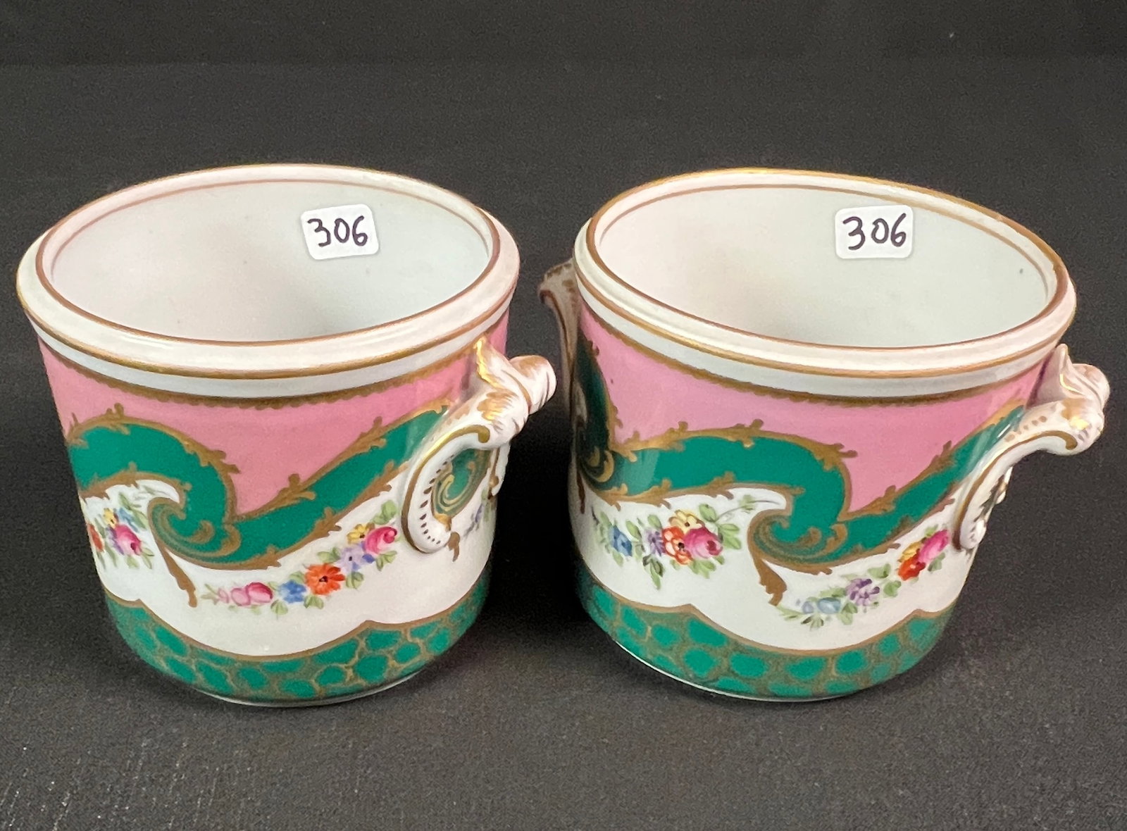 2 Sevres Marked Porcelain Half Bottle Wine Coolers c19th Century: A matching pair of antique French soft paste porcelain floral half bottle wine coolers with gilded handles and the Sevres mark on each in excellent condition. They each measure 4" tall X 5.25" across.