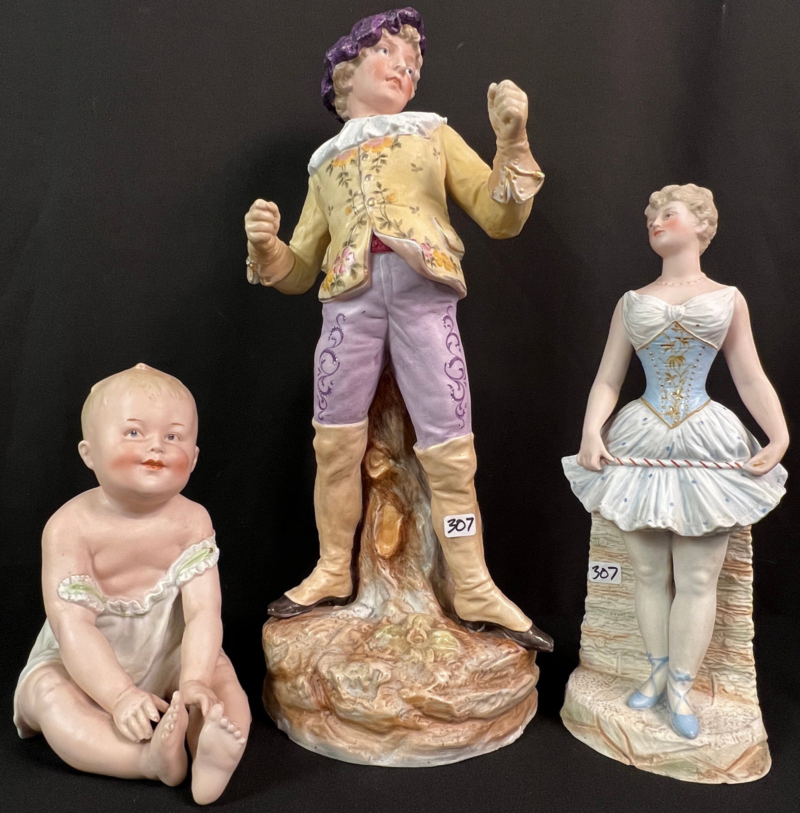 Group of Victorian Bisque Figurines: A group of Victorian Bisque figurines to include a young fencer (made in Germany), a ballerina (made in Germany by Gebruder Heubach) and a piano baby. All in great condition, with light losses to