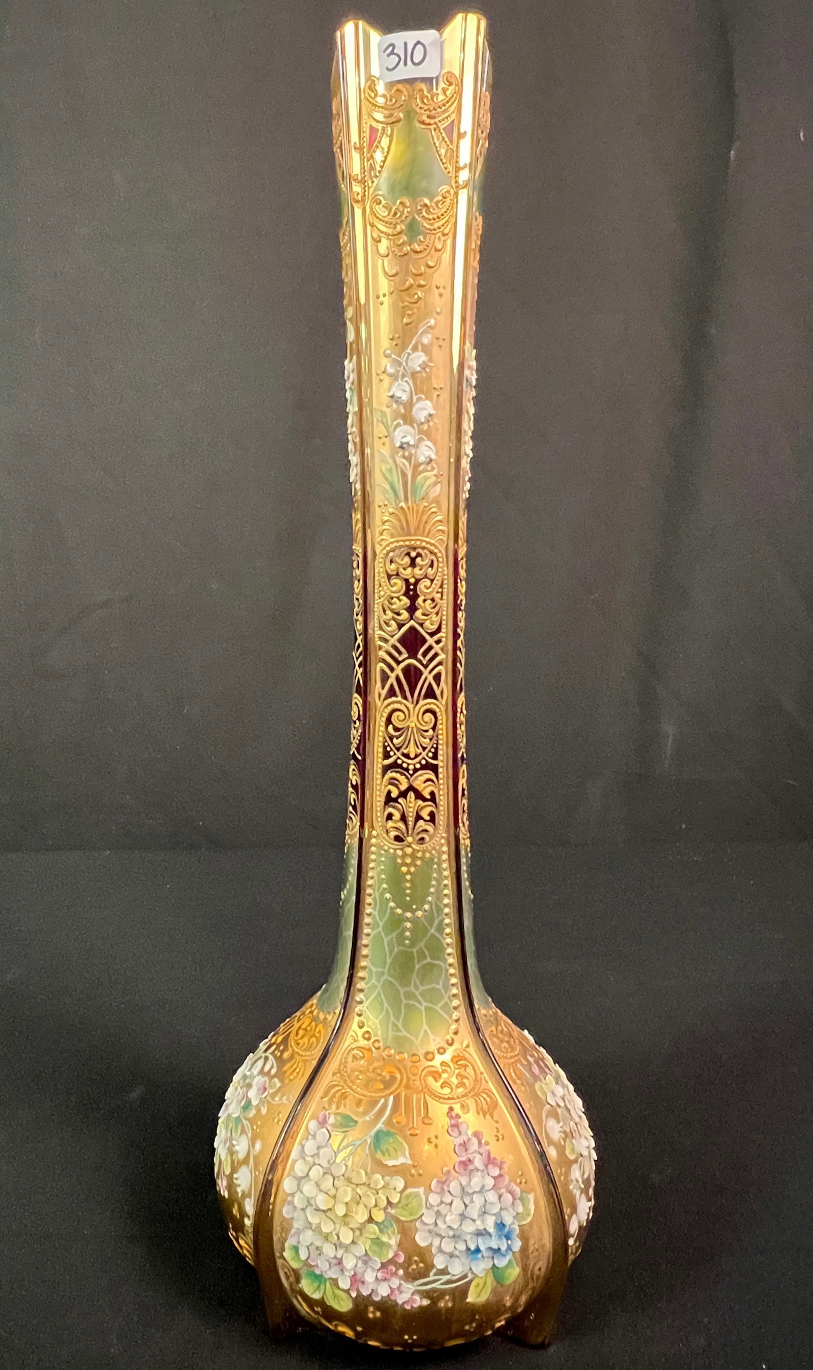 Antique Moser High-Relief Enameled Vase: An antique Moser cranberry to green enameled glass vase. This stunning vase features intricate high-relief floral enameling of lily of the valley and mums with heavy gold gilding. Some very, very