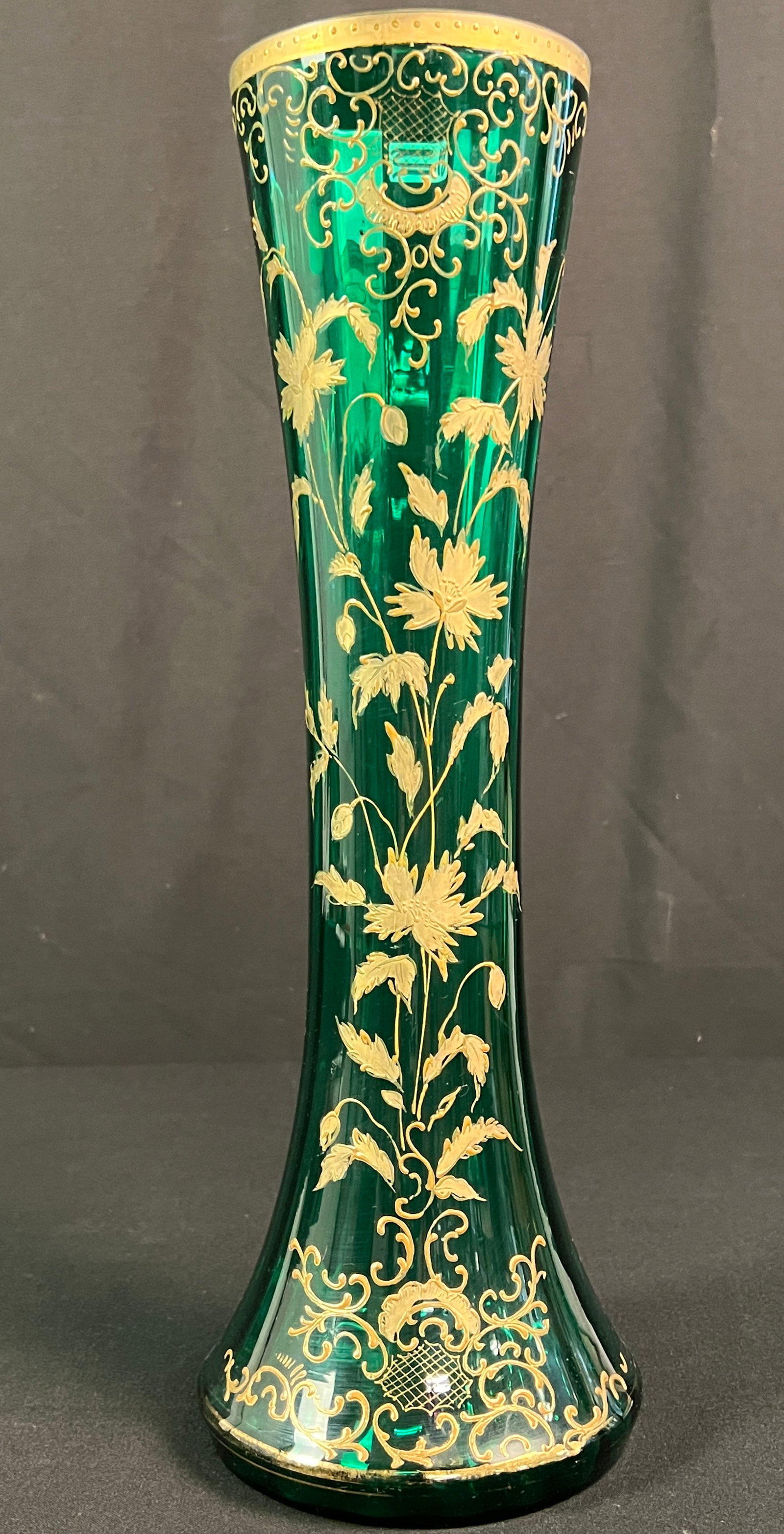 Bohemian Green Art Glass Vase: A bohemian green art glass vase, in the style of Moser. It features hand-painted raised gold gilt and enamel scrolling floral decorations. In good condition, with some wear to the gilding on the