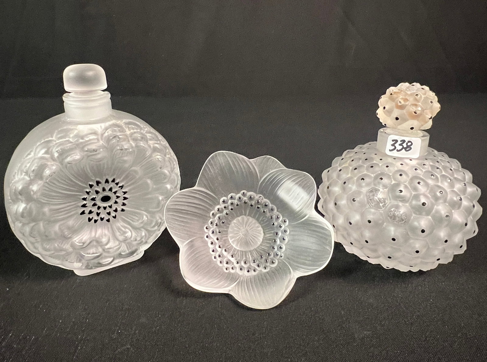 Lalique Scent Bottles, Flower: A Group of Lalique signed crystal to include a Dahlia Scent bottle originally designed in 1931 (5.5" tall X 4.25" across X 2" deep) in excellent condition, a signed Lalique Anemone frosted crystal flo