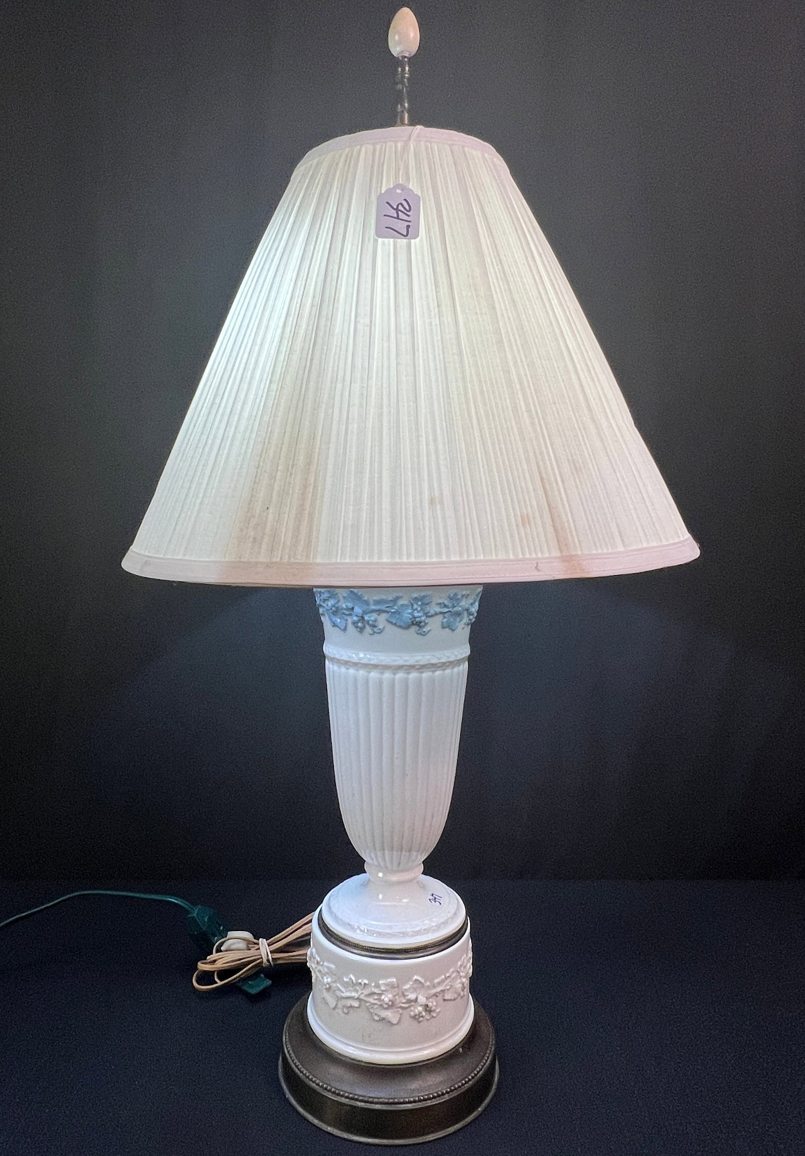 Vintage Wedgewood Queensware Table Lamp c. 1940s: A vintage Wedgewood "Queensware" c. 1940s in the condition that features a white redit, urn-shaped ceramic vase with a blue relief grapevine along top, and 2 pull chain sockets.