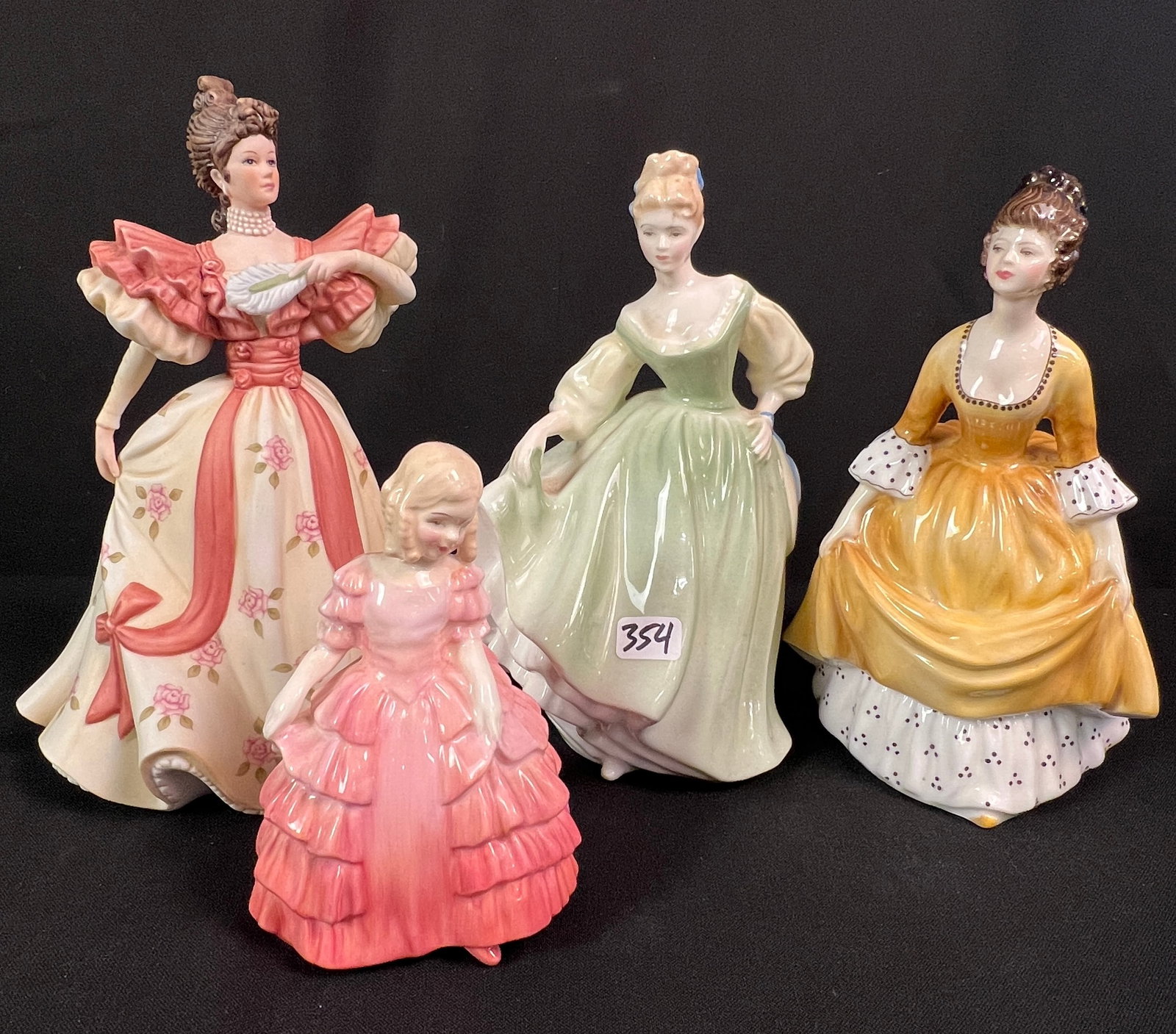 Group of Royal Doulton Lady Figurines More!: A group of Royal Doulton lady figurines to include a young woman in a flowing green gown titled "Fair Lady" in green (8" tall), a lady in a flowing yellow gown and polka-dotted sleeves titled