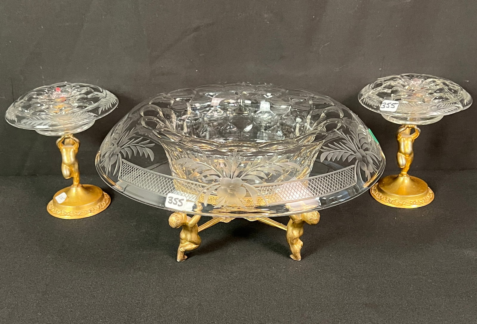 Wheel Cut Crystal Center Bowl and Candlesticks c1920's: A wheel cut crystal bowl and matching candlesticks c 1920's with cupid bases and stems. One crystal candlestick has been repaired, other items in excellent condition. Bowl measures 5.5" tall X 13"