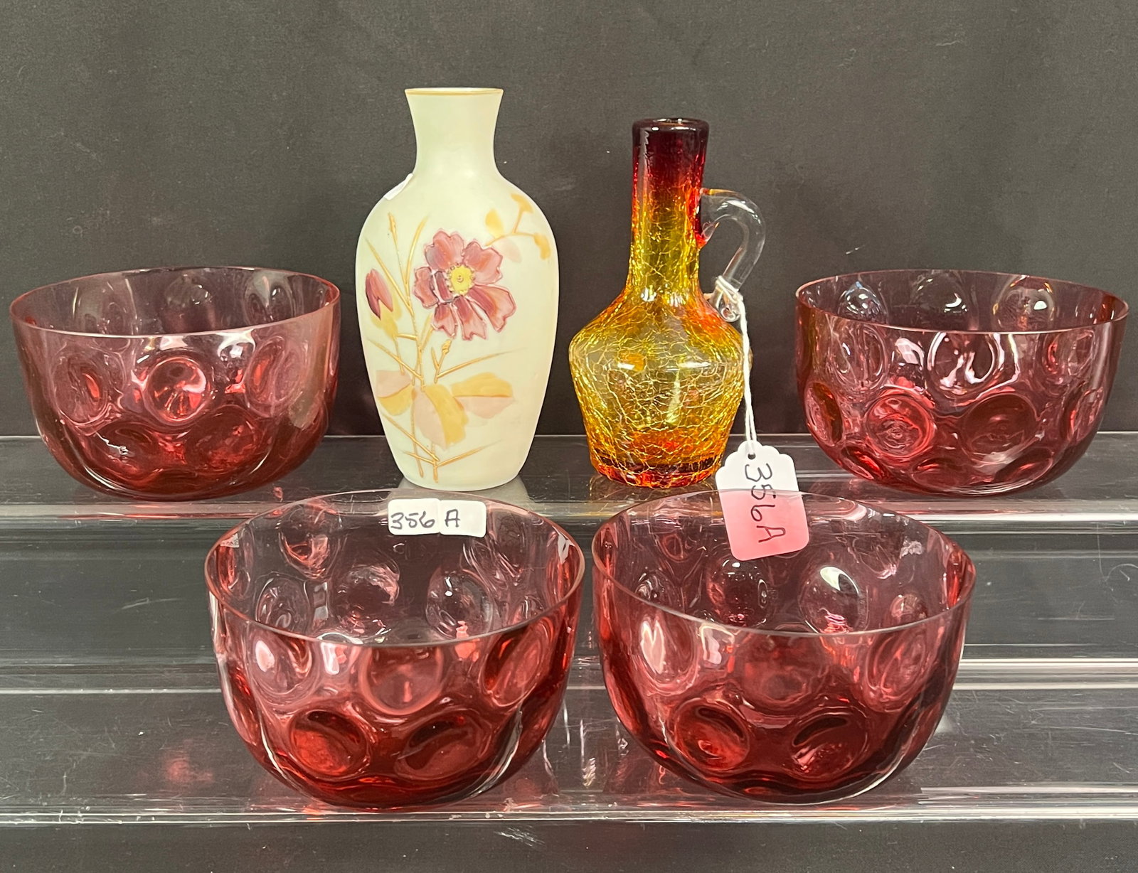 Victorian Art Glass Lot: A Victorian art glass lot to include 4 cranberry thumbprint bowls, a satin glass and enameled vase, and an amberina handled cruet bottle. All in excellent condition.