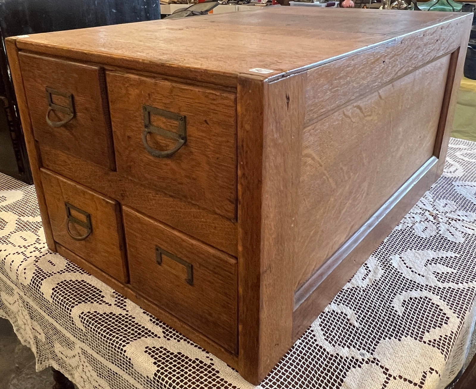 Four Drawer Oak Card File Cabinet: An oak four drawer card file cabinet with chamfered sides. One handle is missing and this may have been a part of something bigger. It measures 13" tall X 17" across X 27.5" deep.