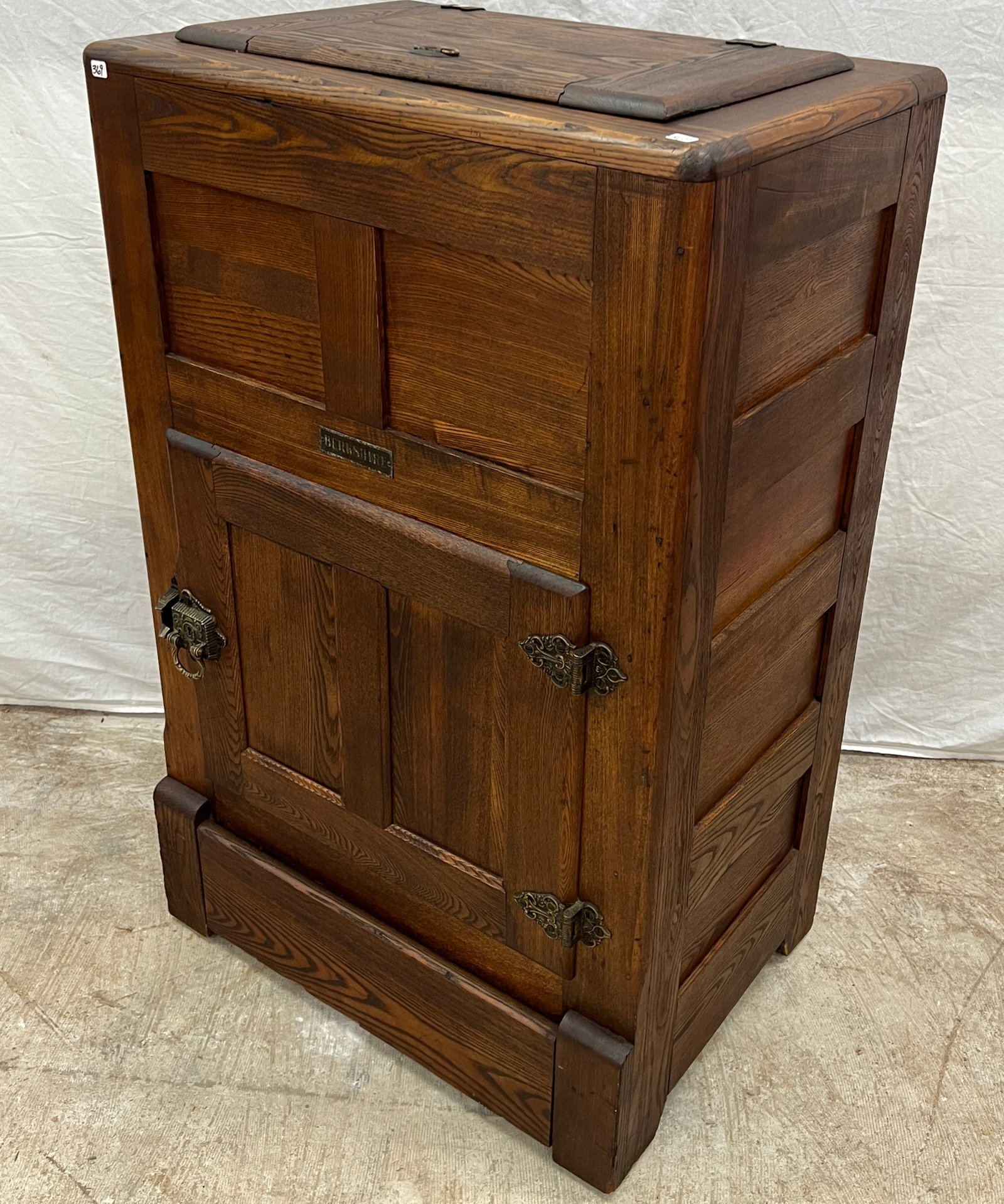 Oak Icebox by Berkshire: A Victorian oak icebox by Berkshire with fancy hardware, chamfered sides and front. In original condition and original finish, it measures 38" tall 24" across X 16" deep.